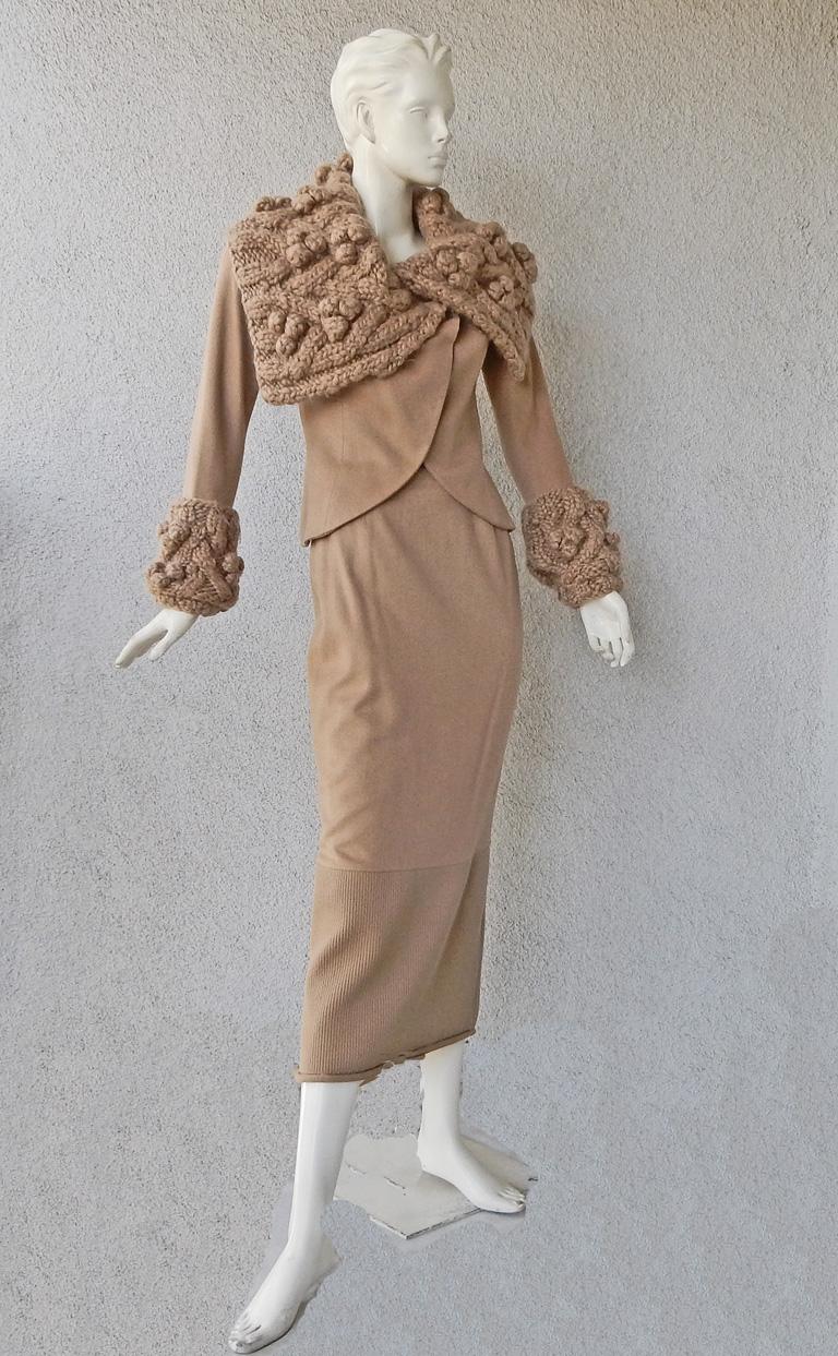 John Galliano for Christian Dior soft camel cashmere wool suit from the Dior collection F/W 1999.   Uniquely designed with asymmetric fitted jacket with sleek midi skirt makes a high fashion statement. Skirt fully lined; 7 back buttons with knitted