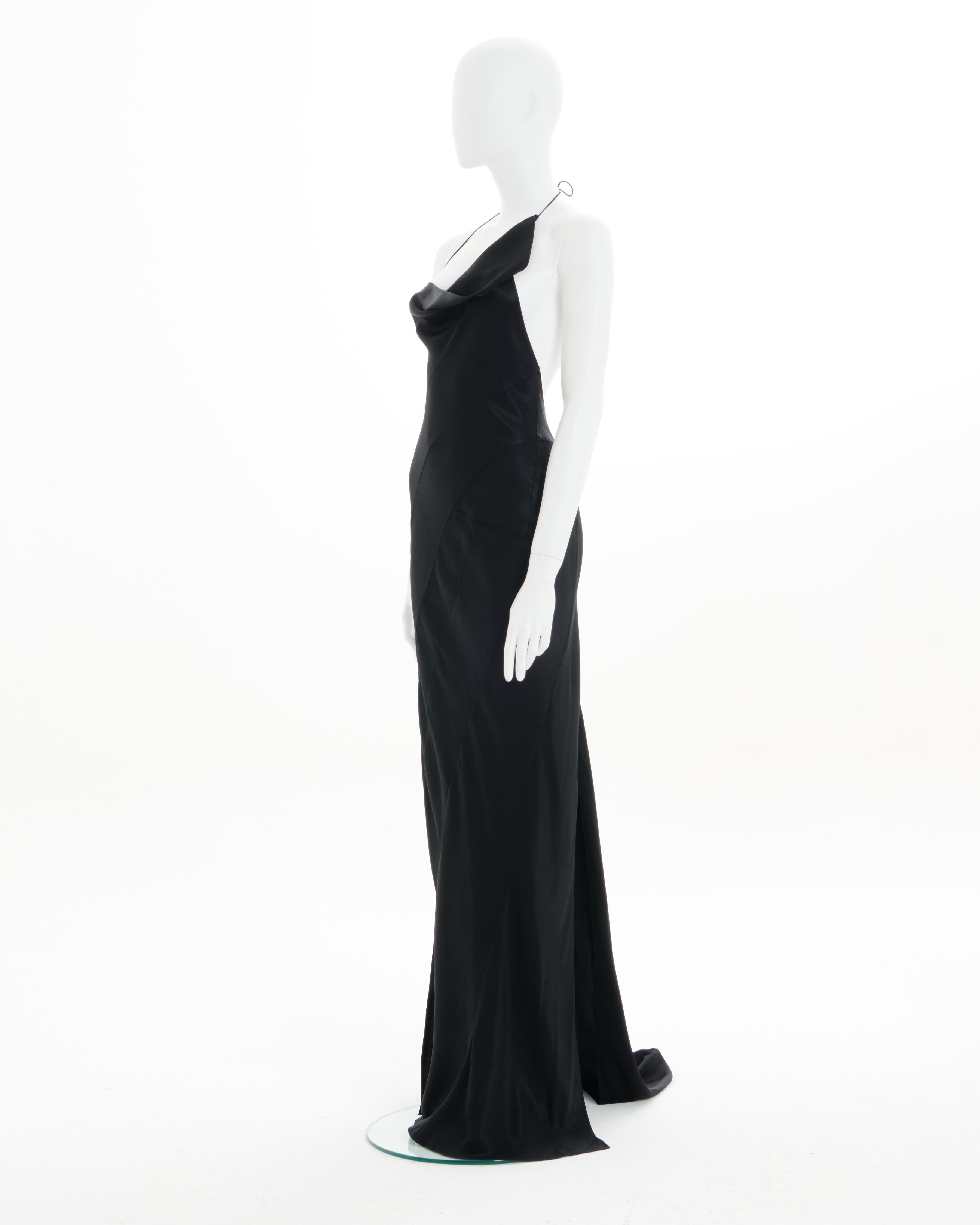 - Archival Christian Dior Evening Dress
- Sold by Skof.Archive
- Creative Director : John Galliano 
- Fall - Winter 2000
- Crafted from different panels of black bias-cut silk satin
- Adjustable American neckline 
- Floor-length skirt with train 
-