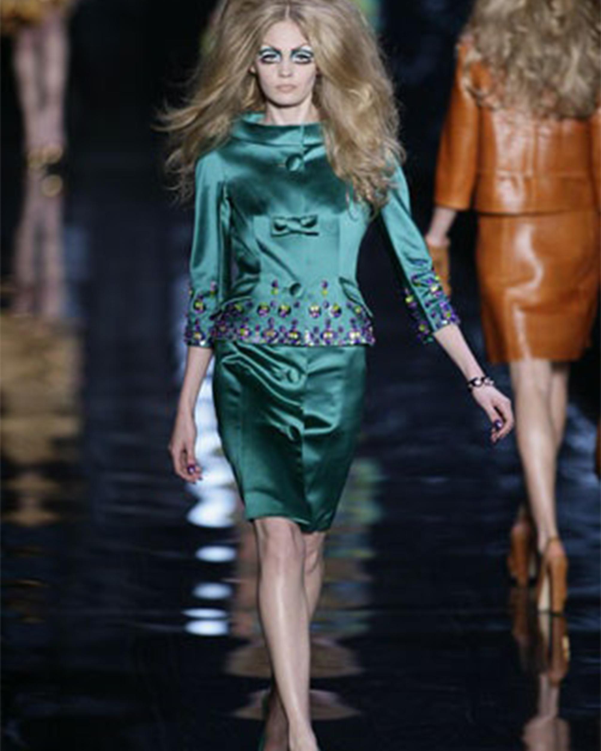 - Designed by John Galliano
- Sold by Skof.Archive
- Fall Winter 2008 Collection
- Runway Look 31
- Wool Blue Jacket
- Button Up Closure with Bow detail
- Large Neck
- Two Pockets
- Three-quarter sleeve
- Blue Midi Dress
- Button Details
- Short