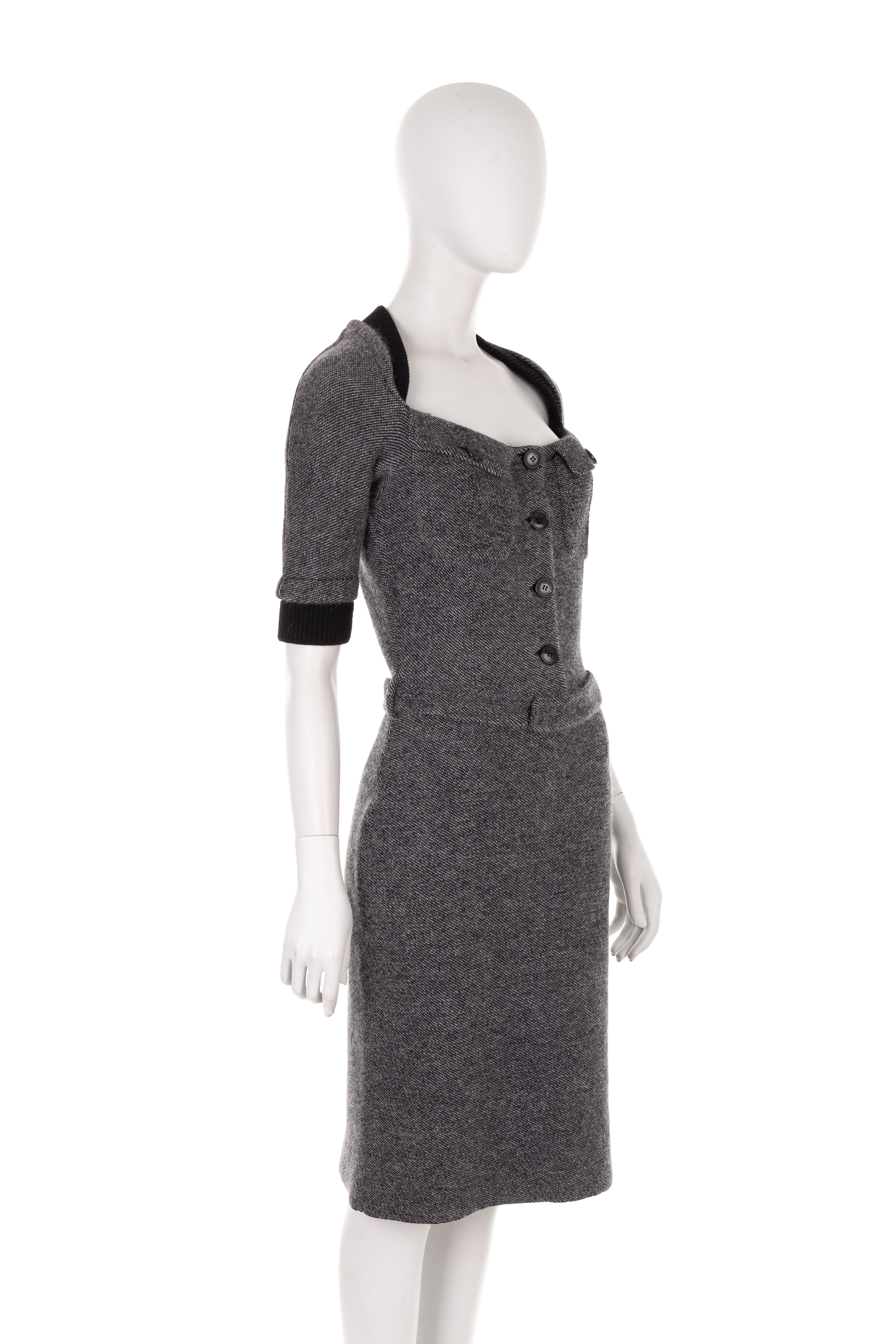 - Christian Dior by John Galliano
- Sold by Gold Palms Vintage
- Fall Winter 2010 collection
- Grey wool-cashmere tweed midi dress
- Black wool ribbed knit collar and cuffs
- 3/4 sleeves
- Buttoned-up chest
- Two front buttoned chest pockets
- Mini