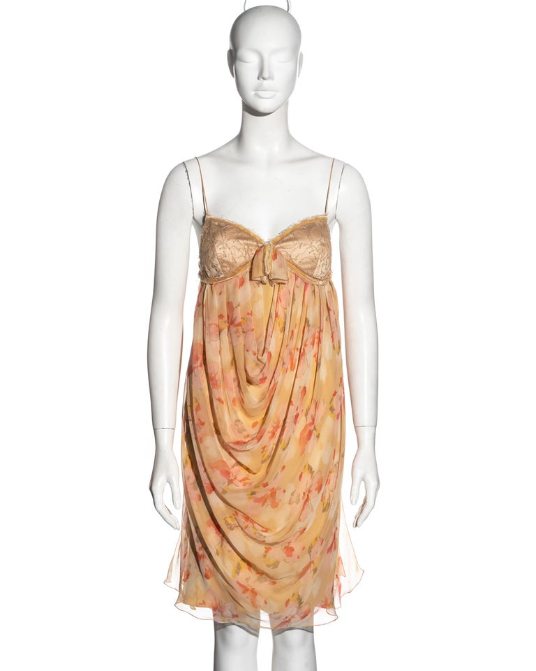▪ Christian Dior dress
▪ Designed by John Galliano
▪ Apricot floral printed silk chiffon 
▪ Velvet trim 
▪ Lace bust 
▪ Draped skirt 
▪ Spaghetti straps
▪ Fabric buttons at the side opening 
▪ Silk lining 
▪ FR 40 - UK 12 - US 8
▪ Fall-Winter 2005
▪