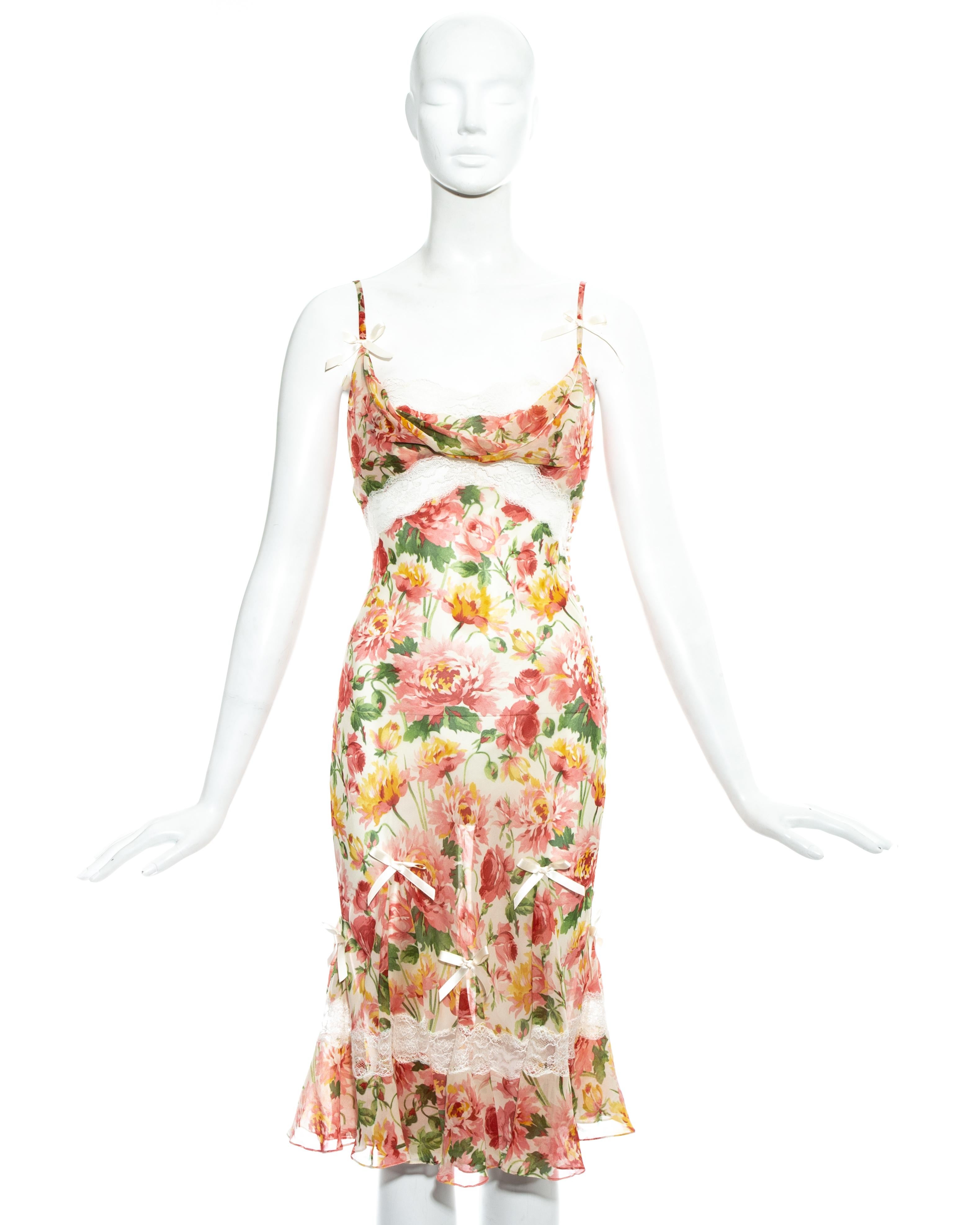 Christian Dior by John Galliano; floral silk chiffon and lace mid-length bias cut dress.  

 - White lace inserts and trim 
- Decorative silk ribbon bows  
- 27 fabric button fastenings on side seam  
- Sold with optional slip dress  