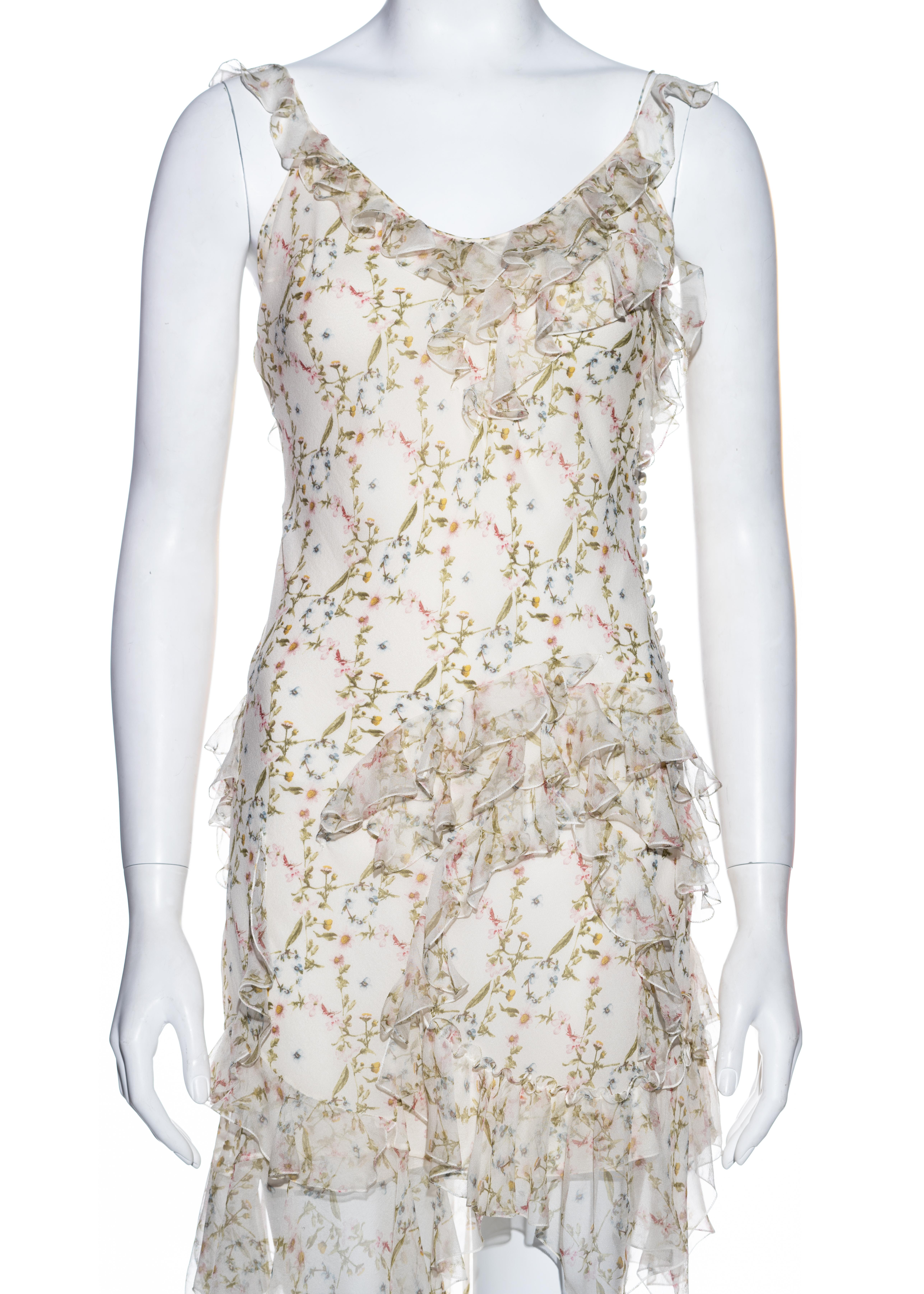 ▪ Christian Dior silk chiffon mini dress
▪ Designed by John Galliano 
▪ Green, pink, blue and yellow floral print with ivory base 
▪ Spaghetti straps 
▪ Flounces encircling the skirt and bodice 
▪ Fabric button fastenings on side seam 
▪ FR 38 - UK