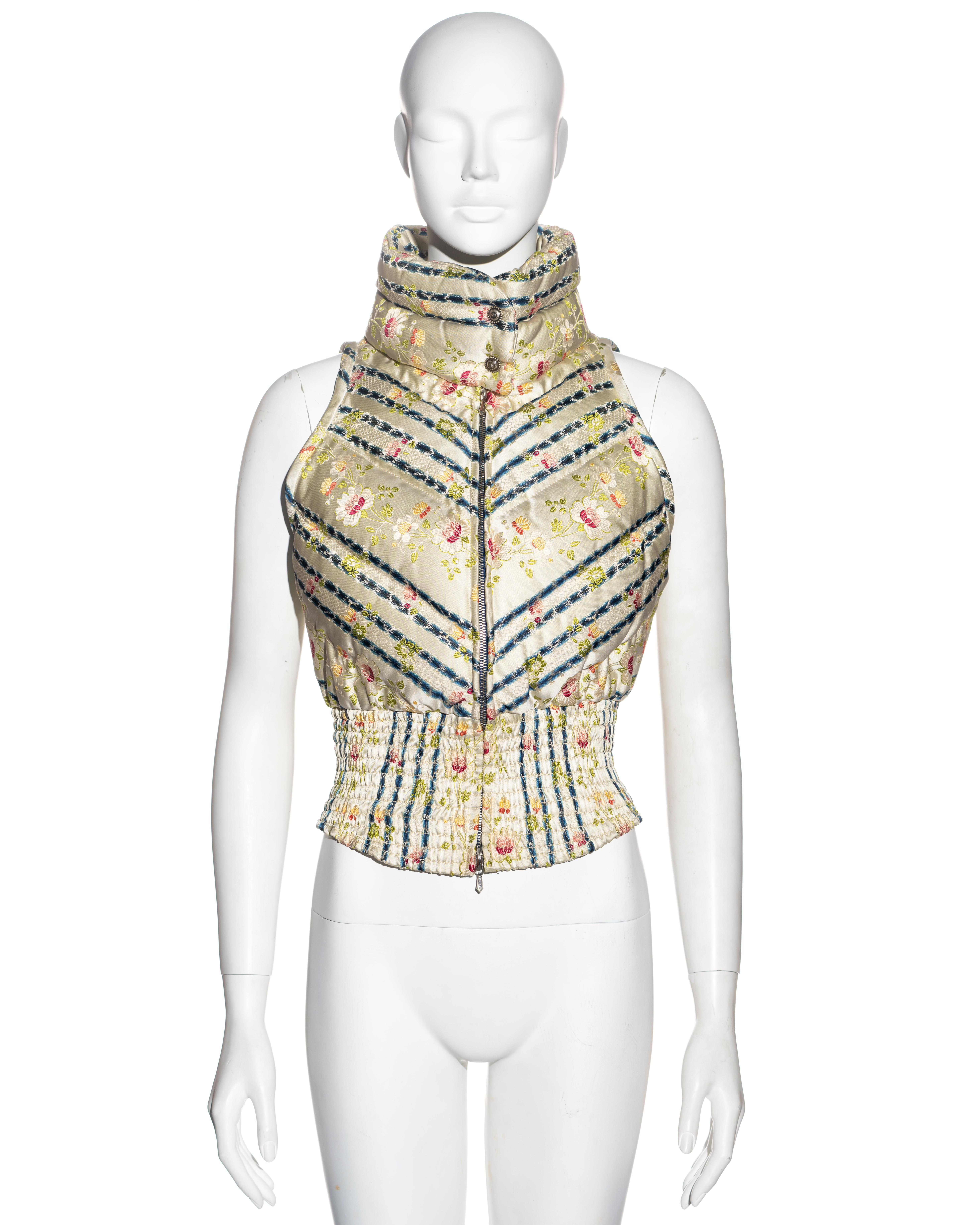▪ Christian Dior down vest
▪ Designed by John Galliano
▪ Sold by One of a Kind Archive
▪ Constructed from silk brocade with floral and striped pattern 
▪ Wide smocked waistband 
▪ Silk lining 
▪ Double-ended front zipper 
▪ High neck
▪ Size: FR 38 -