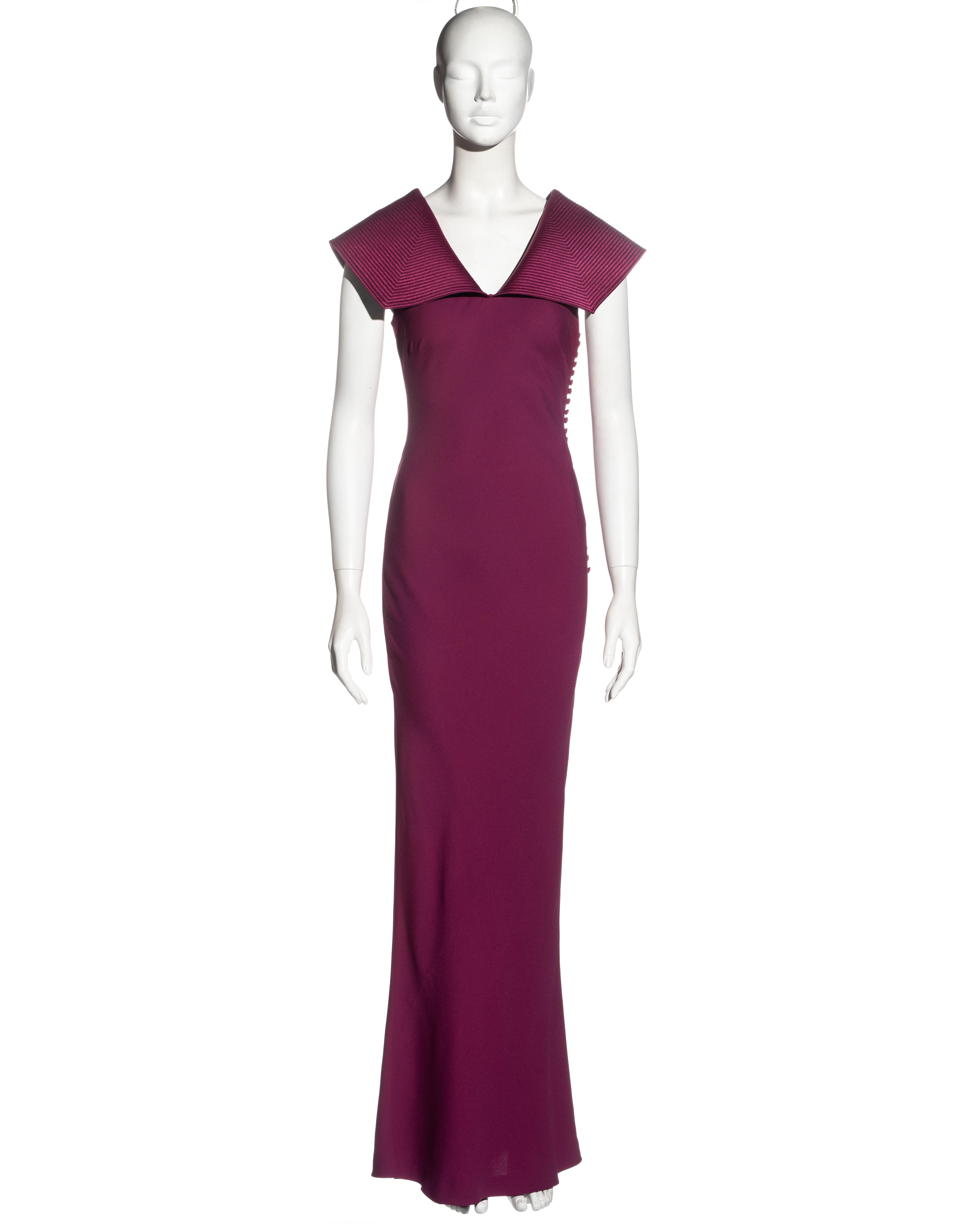 ▪ Christian Dior evening dress
▪ Designed by John Galliano
▪ Fuchsia crepe satin 
▪ Bias cut 
▪ Multiple fabric covered buttons at the side opening 
▪ Wide collar extending over the shoulders with multiple parallel stitches 
▪ FR 40 - UK 12 - US 8
▪