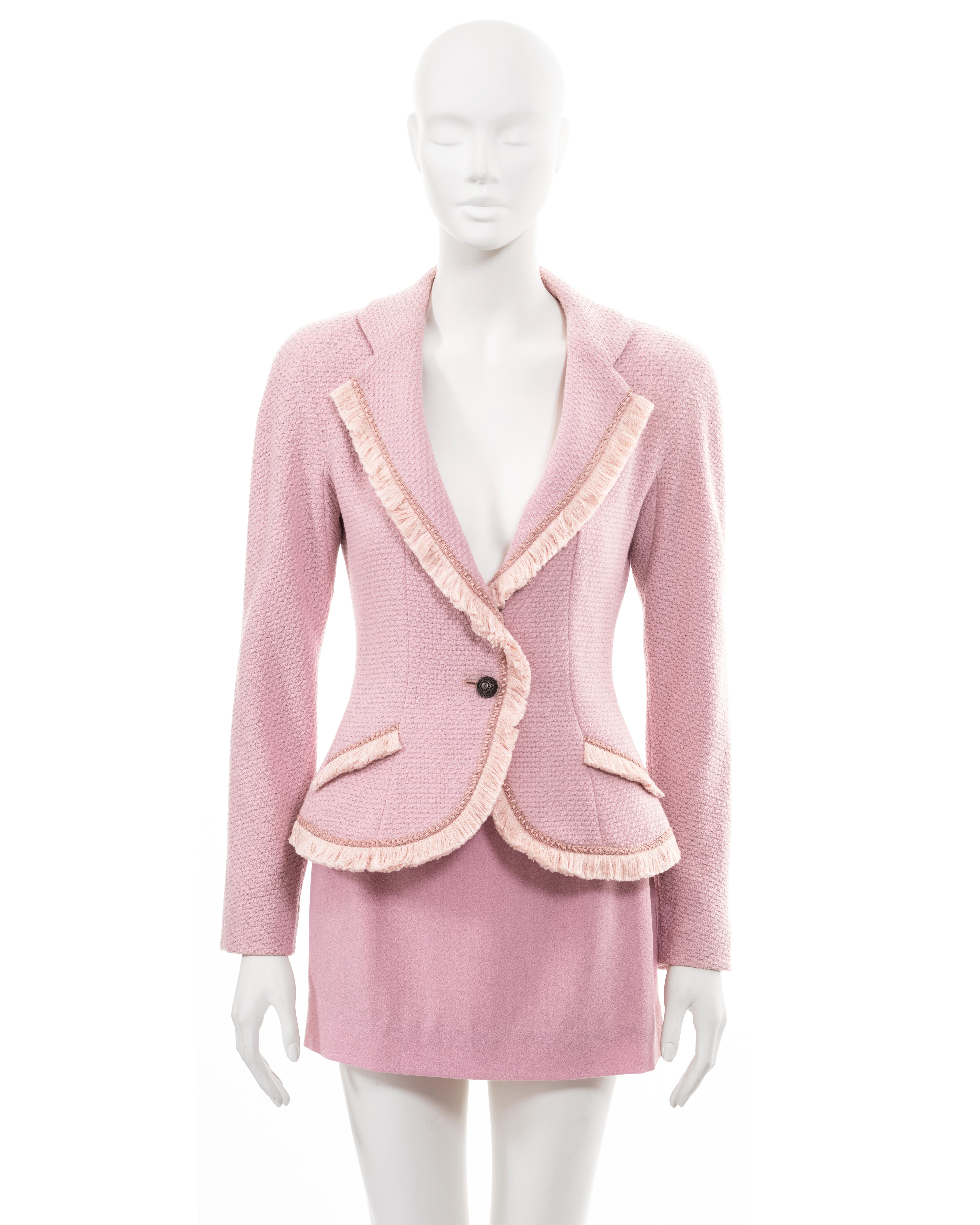 ▪ Christian Dior pink mini skirt suit
▪ Creative Director: John Galliano
▪ Sold by One of a Kind Archive
▪ Fall-Winter 1997 
▪ Single-breasted blazer jacket in pink wool 
▪ Trimmed with fringes of silk threads
▪ Padded shoulders and hips 
▪ Mini