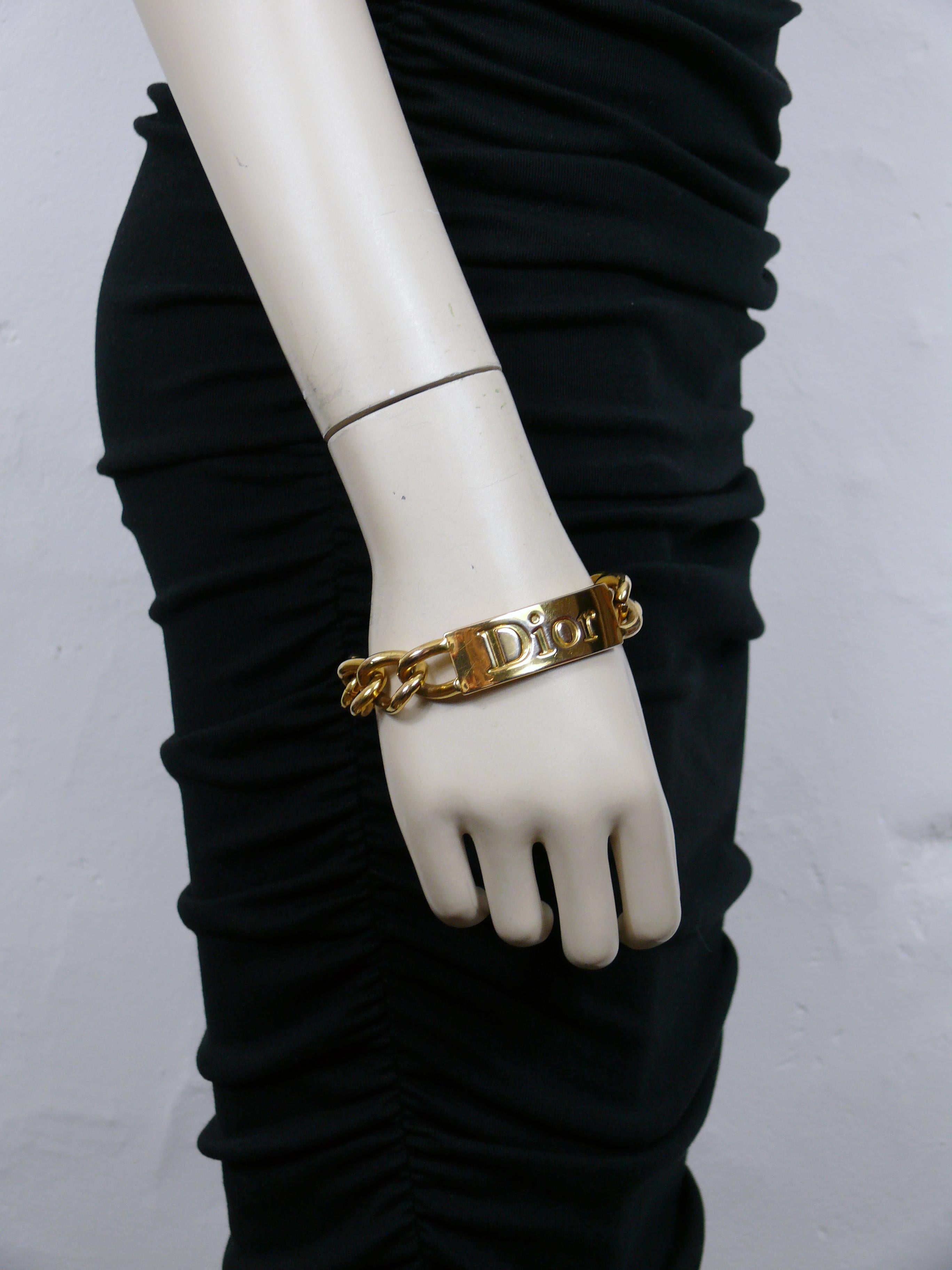 CHRISTIAN DIOR by JOHN GALLIANO gold tone bracelet featuring curb links and ID tag embossed DIOR.

Lobster clasp closure.

Embossed DIOR ©.

Indicative measurements : length approx. 20.5 cm (8.07 inches)  / link width 1.5 cm (0.59 inch).

Materials