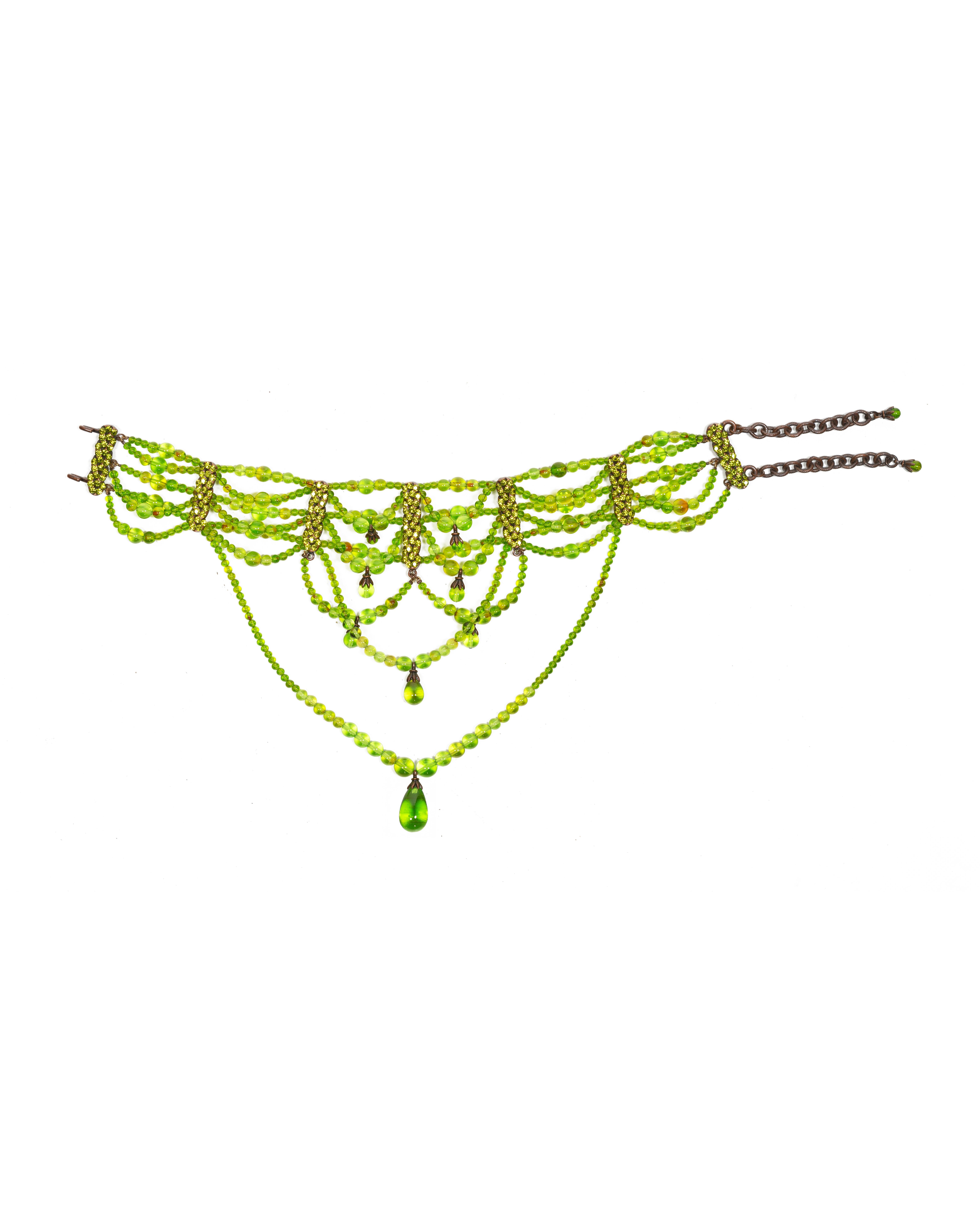This rare choker necklace from Christian Dior’s Fall-Winter 2003 collection, designed by John Galliano, features an intricate construction of layered chartreuse-green glass beads. The design consists of multiple strands of varying bead sizes, draped