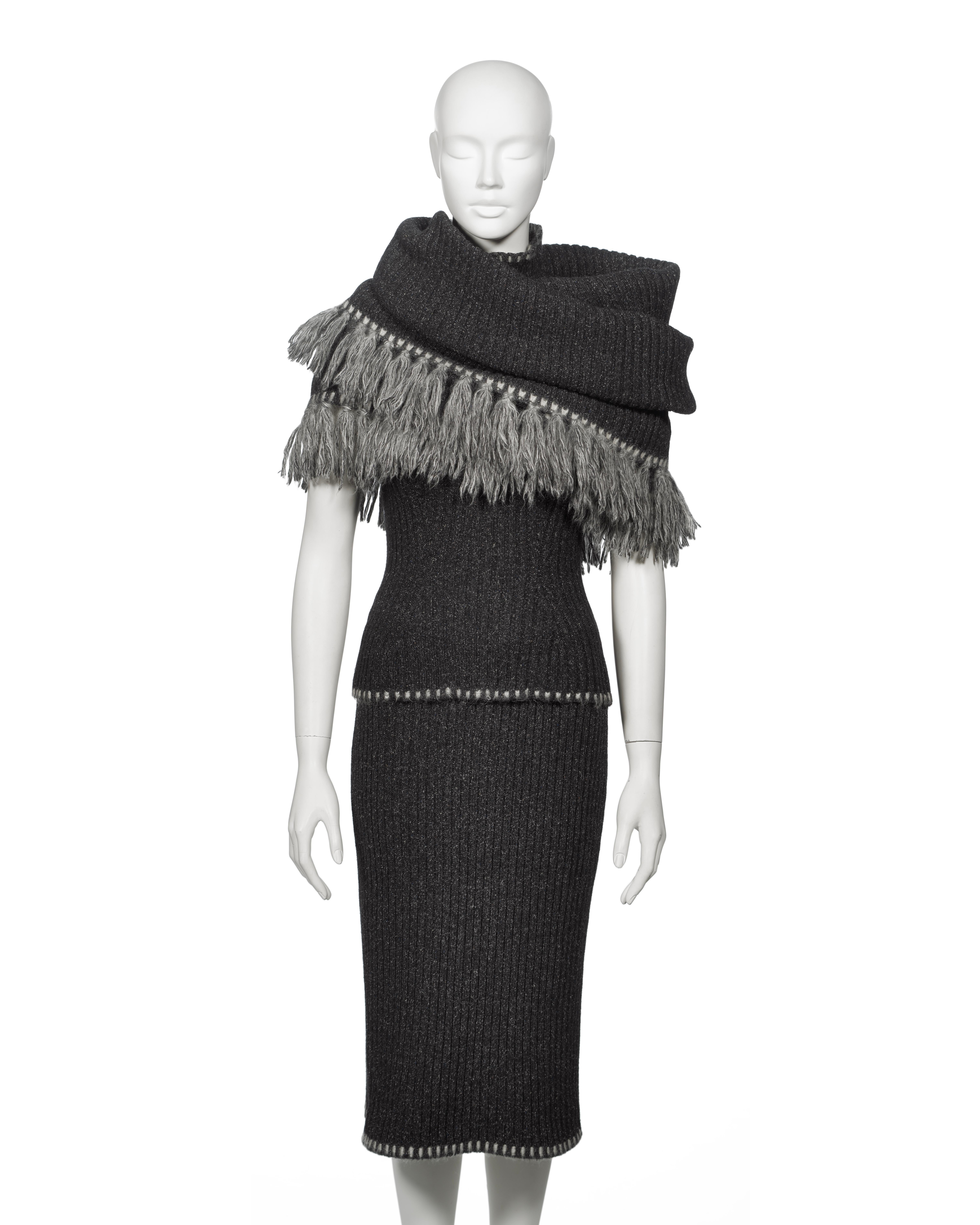 This Christian Dior by John Galliano ensemble from the Fall-Winter 1999 collection is crafted from a luxurious blend of wool, nylon, mohair, silk, and Angora. It features a ribbed turtleneck top and pencil skirt, both finished with contrast