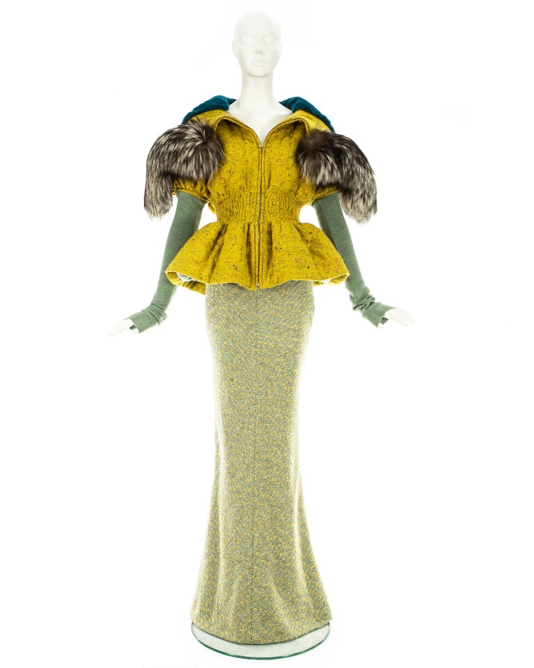 Christian Dior by John Galliano; Mustard tweed quilted jacket with oversized fox fur hood, accentuated waist and detachable knitted sleeves. Mint green tweed full length fishtail skirt with silk lame lining. 

Fall-Winter 1998

(Jacket) Waist: 22