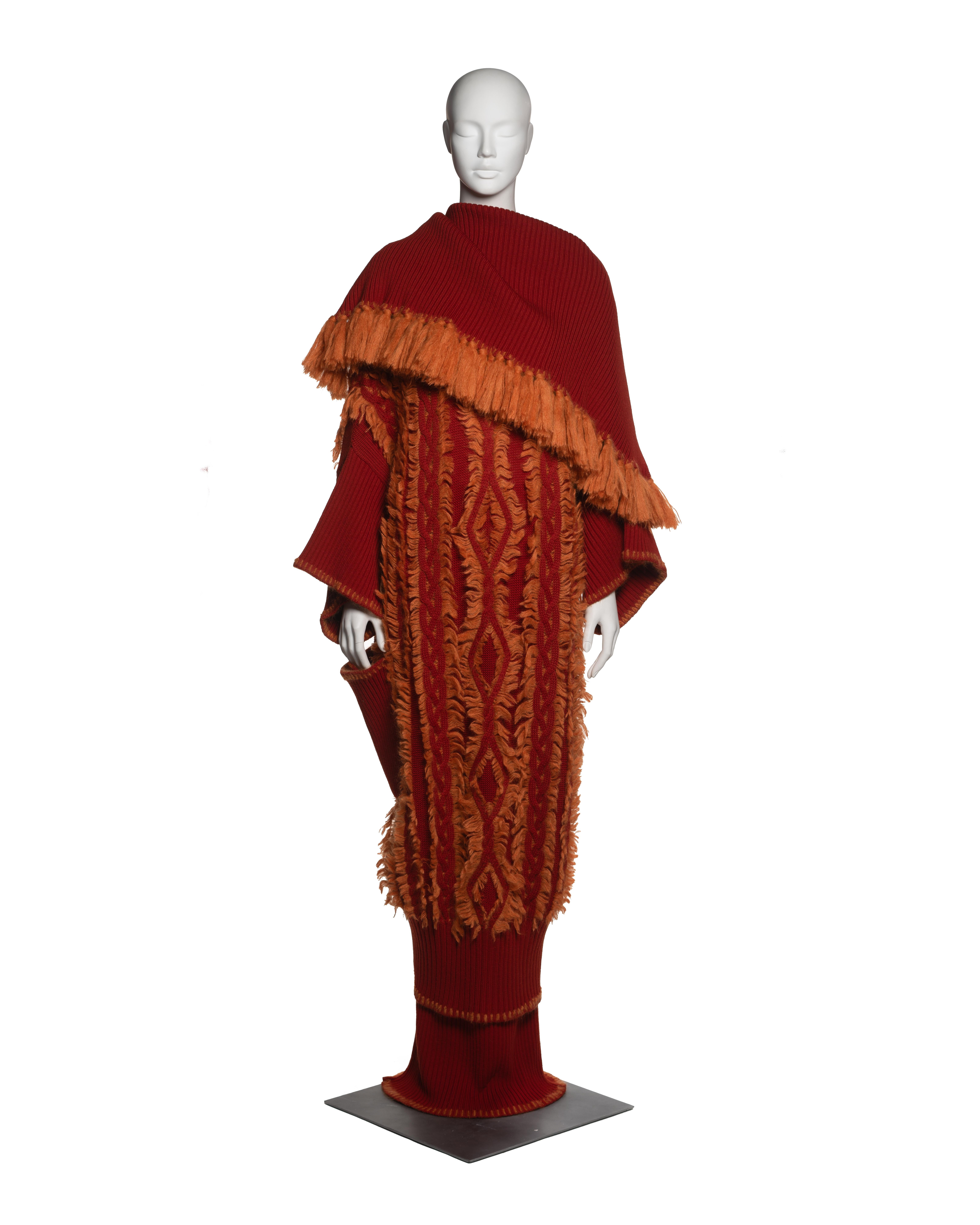 Christian Dior by John Galliano knitted coat and skirt ensemble, Fall-Winter 1999. Constructed from heavy-gauge wool in deep red with contrasting burnt orange mohair appliqué. The oversized coat features an exaggerated shawl collar, asymmetrically