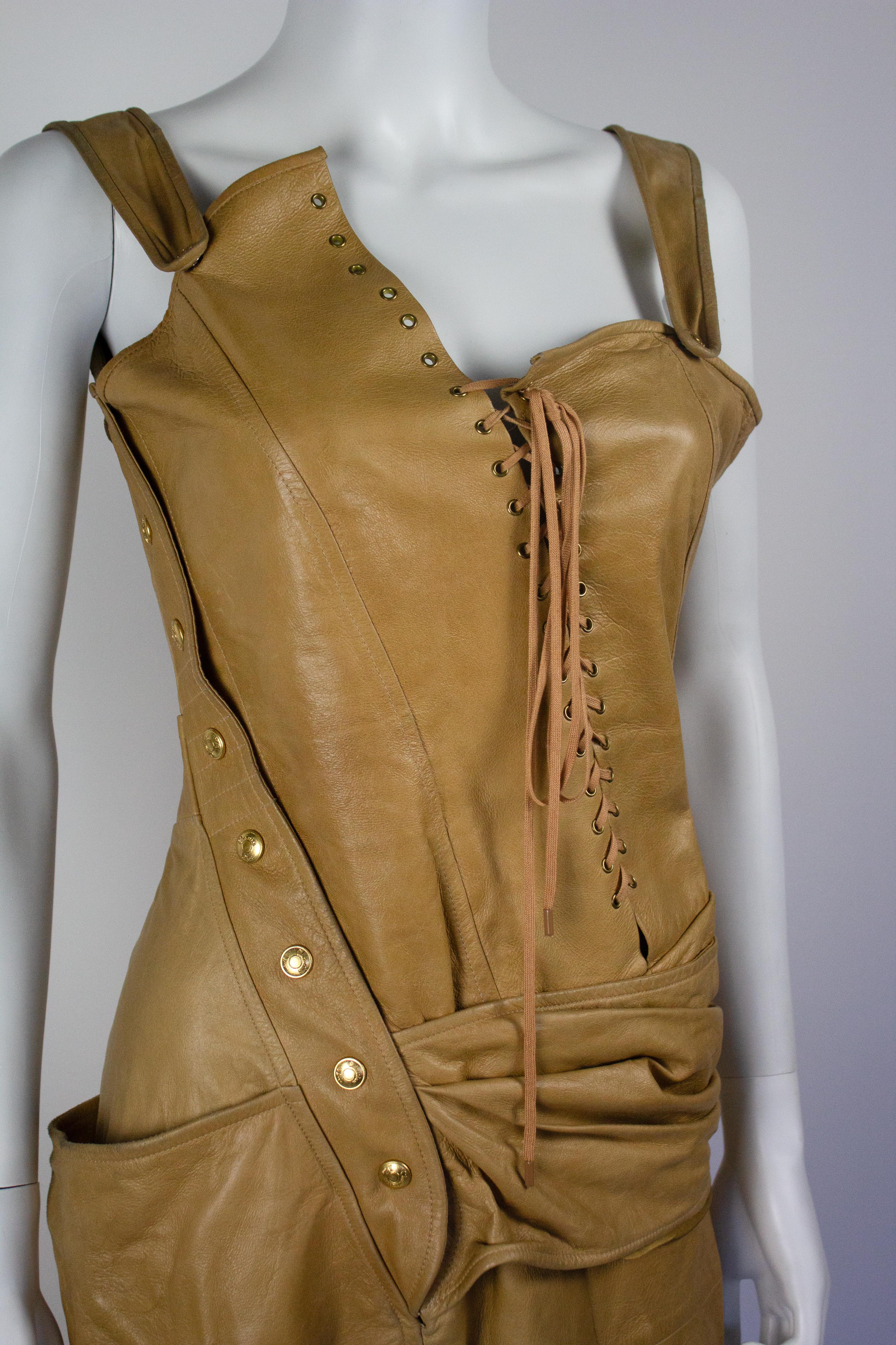 Christian Dior deconstructed tan leather dress from the Spring/Summer 2000 collection, designed by John Galliano. As seen on the runway. Corset style lace up detail to the front.

Condition
Good. The leather has an overall aged look. A few minor
