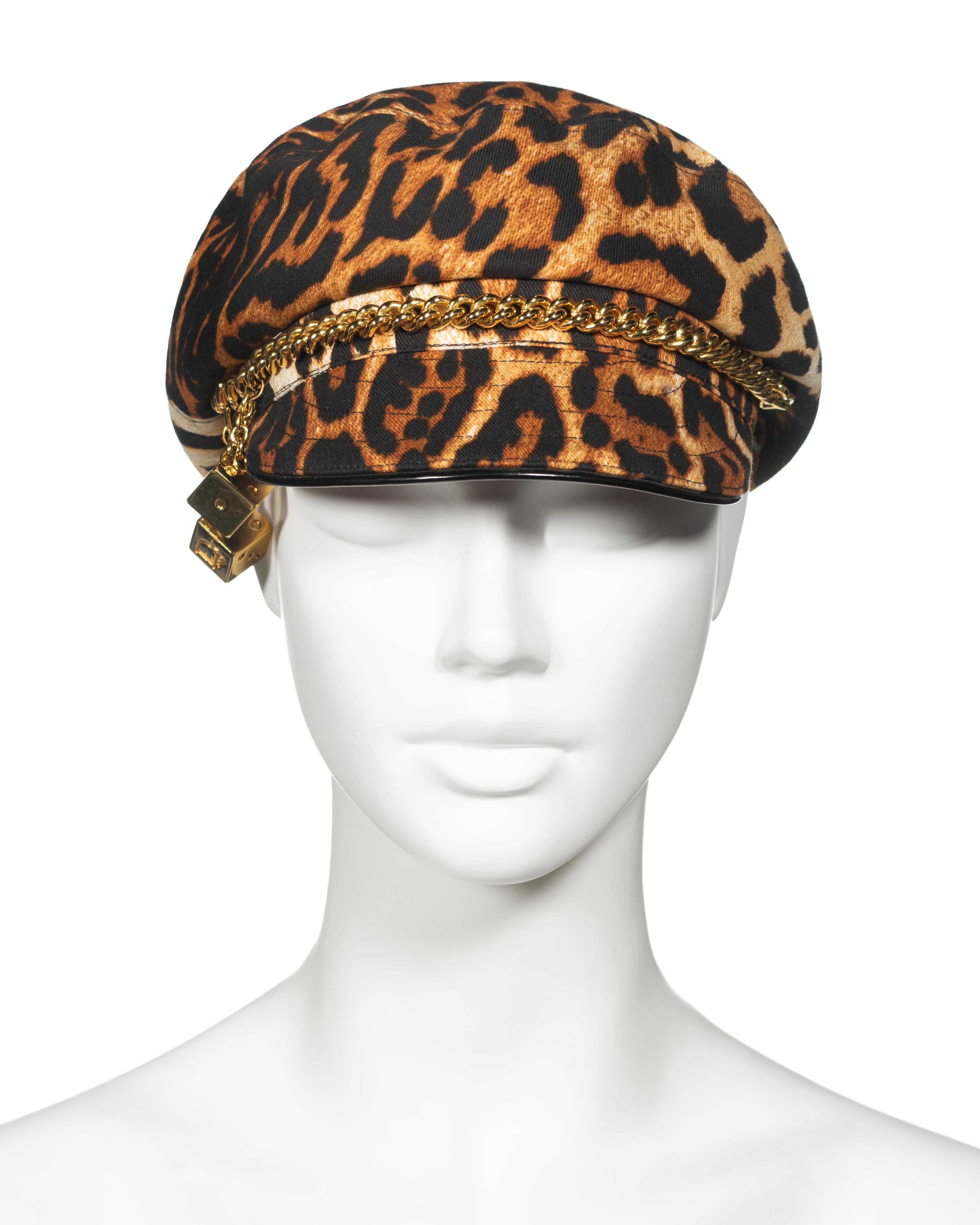 ▪ Christian Dior Bakerboy 'Gambler' Cap 
▪ Creative Director: John Galliano
▪ Fall-Winter 2004
▪ Crafted from robust cotton twill adorned with a leopard print
▪ Accented with a decorative gilt metal chain and two dangling dice at the crown's base
▪