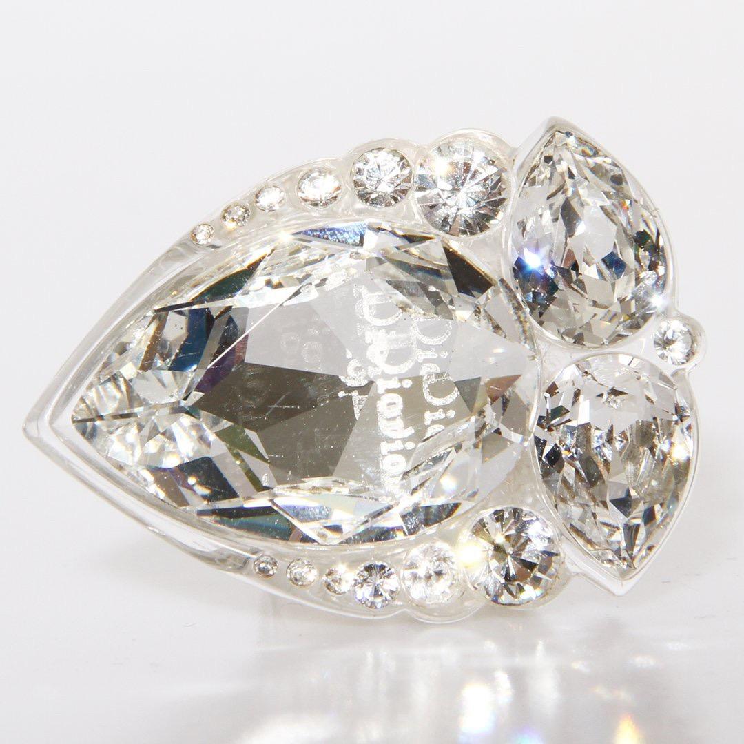 Christian Dior by John Galliano lucite crystal cocktail ring circa Early-Mid 2000's. Overall details include: clear lucite base, oversized pear-shaped crystals, and smaller circular crystals. The Dior logo is laser engraved engraved on the center