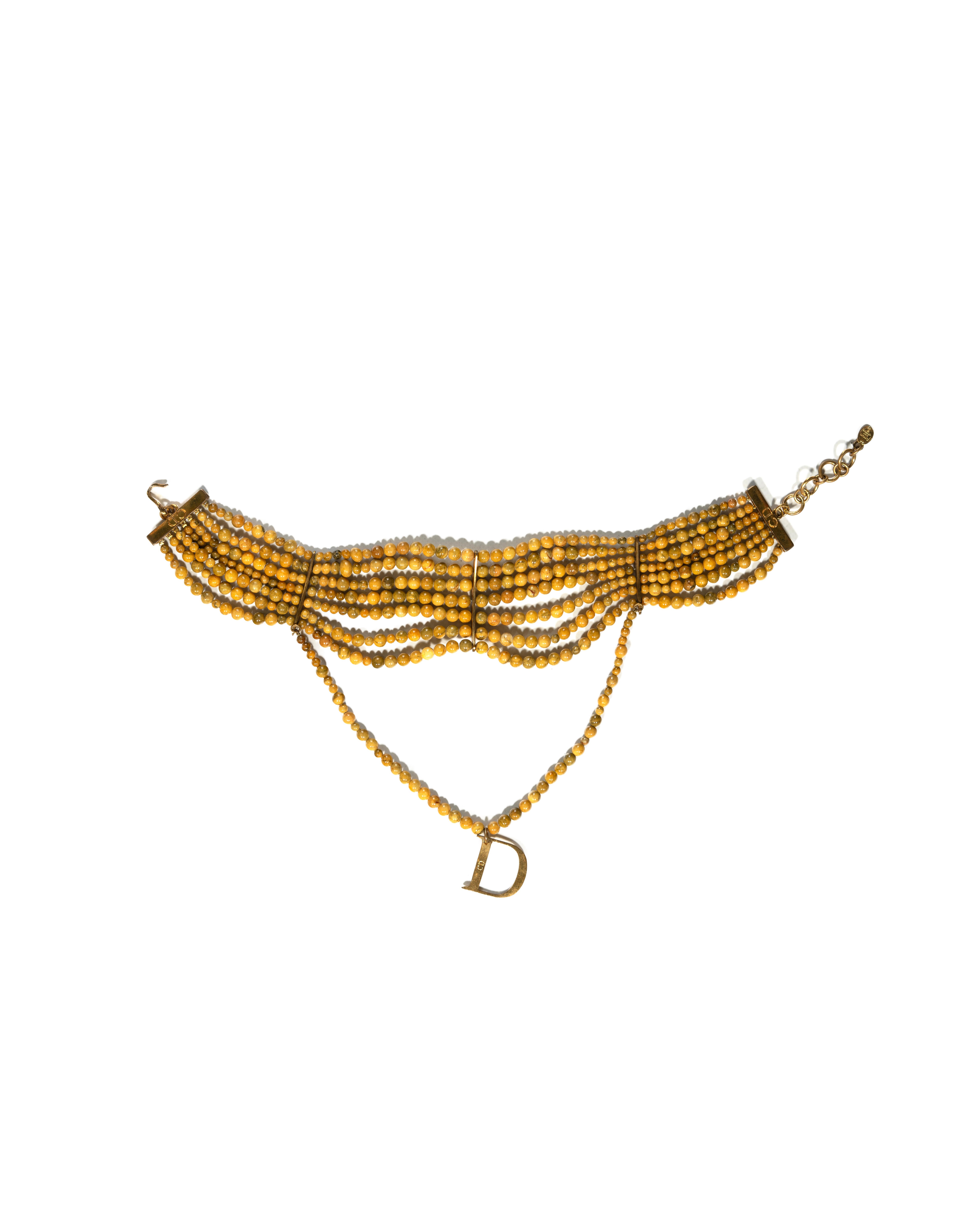 ▪ Archival Christian Dior 'Masai' Choker Necklace 
▪ Creative Director: John Galliano 
▪ c. 1998  
▪ Sold by One of a Kind Archive 
▪ Embellished with 7 strands of exquisite marbled glass beads 
▪ The centerpiece boasts an additional hanging strand
