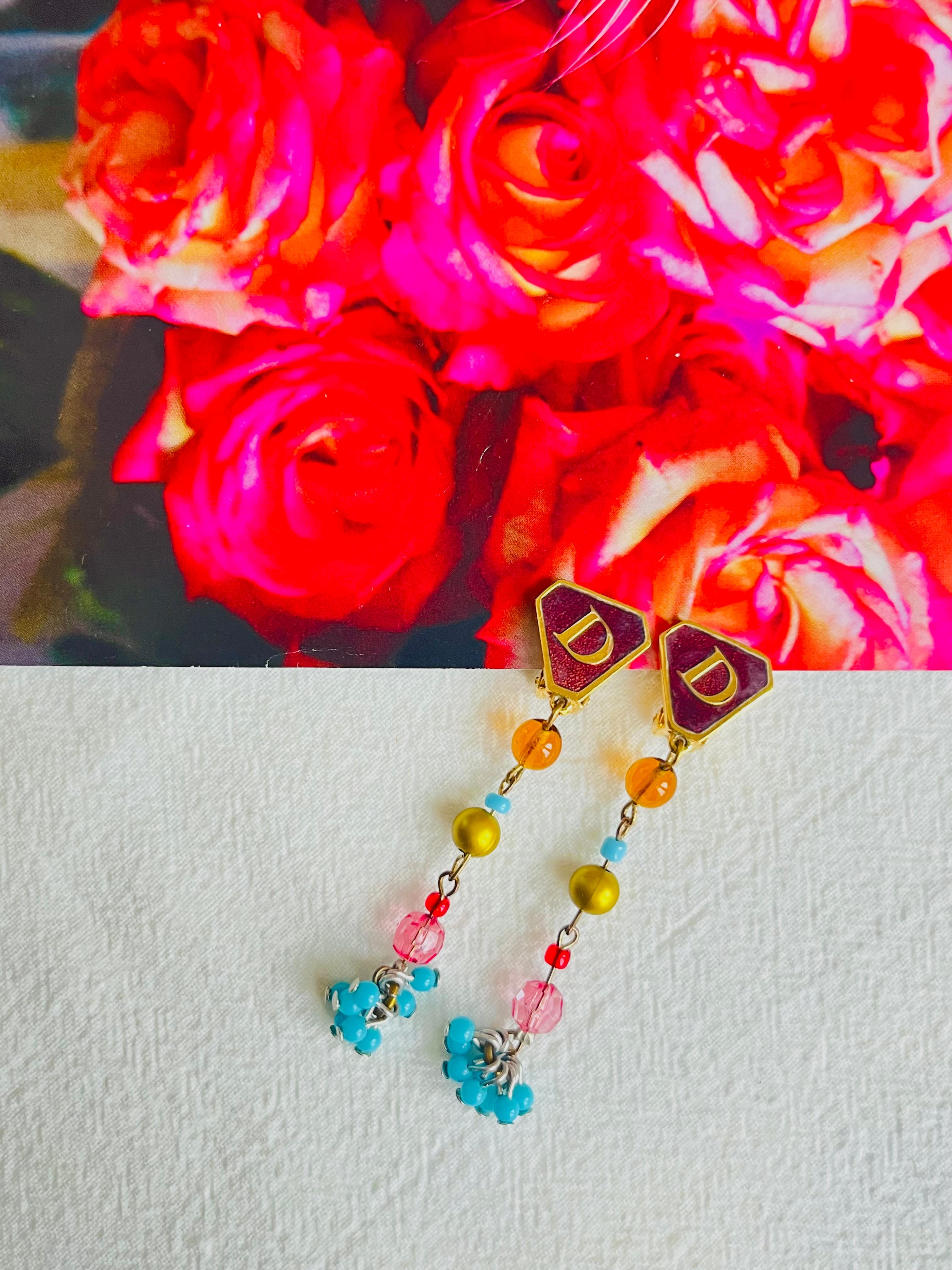 CHRISTIAN DIOR by John Galliano Masai Vintage 1990s Gripoix Logo D Tassel Long Clip Earrings, Gold Tone 

Elaborate coloured poured glass/ gripoix in hues of red, green, amber and turquoise. Triangular enamel plate with letter D.

Very excellent
