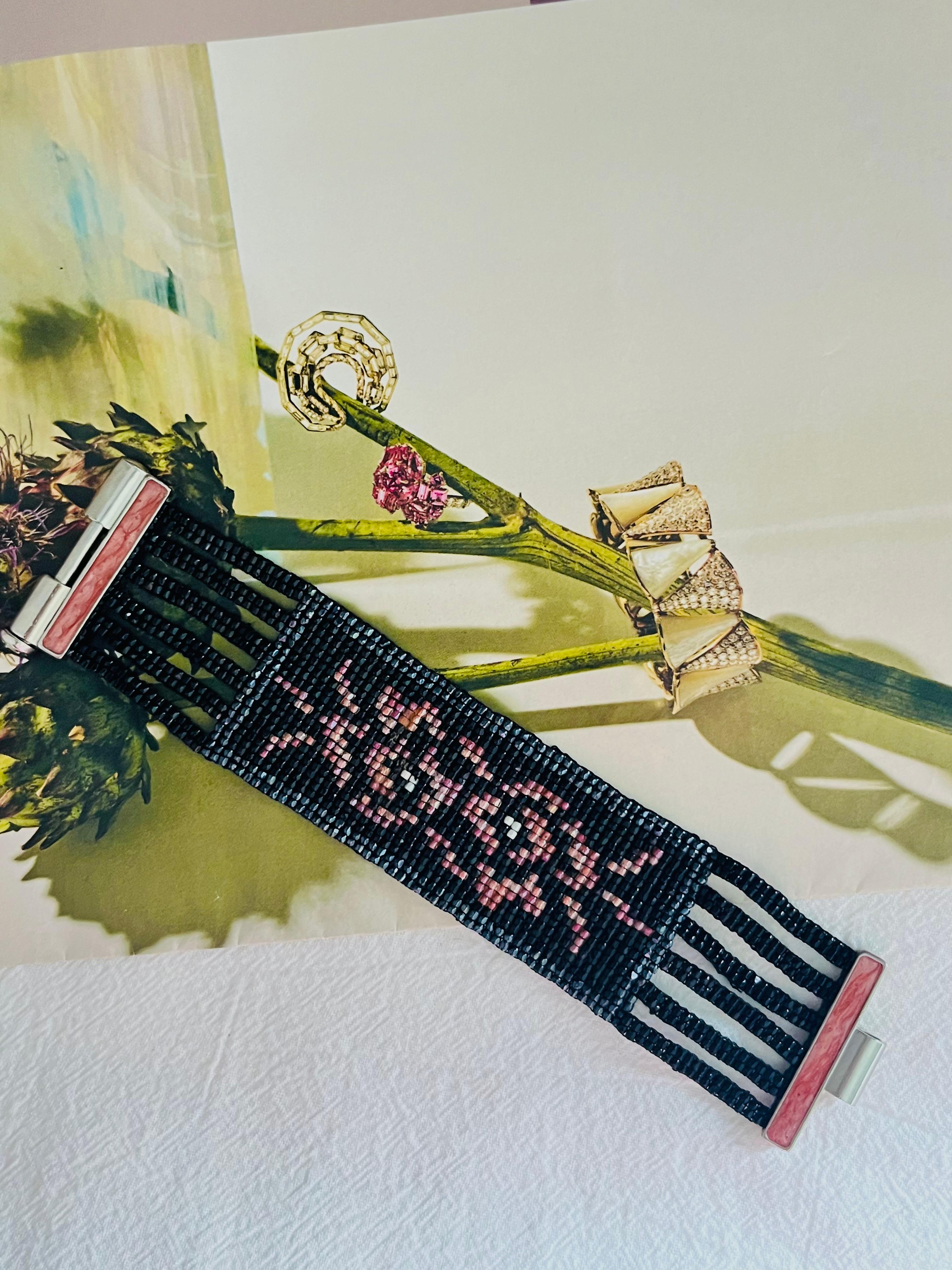 Christian Dior by John Galliano Masai 1997 Beads Black Red Pink Flower Camellia Link Six 6 Layers Strands Openwork Interlink Bracelet, Silver Plated

Very excellent condition. Very rare to find. 100% Genuine. Marked at closure. 

Size: 16.8*3.5 cm.
