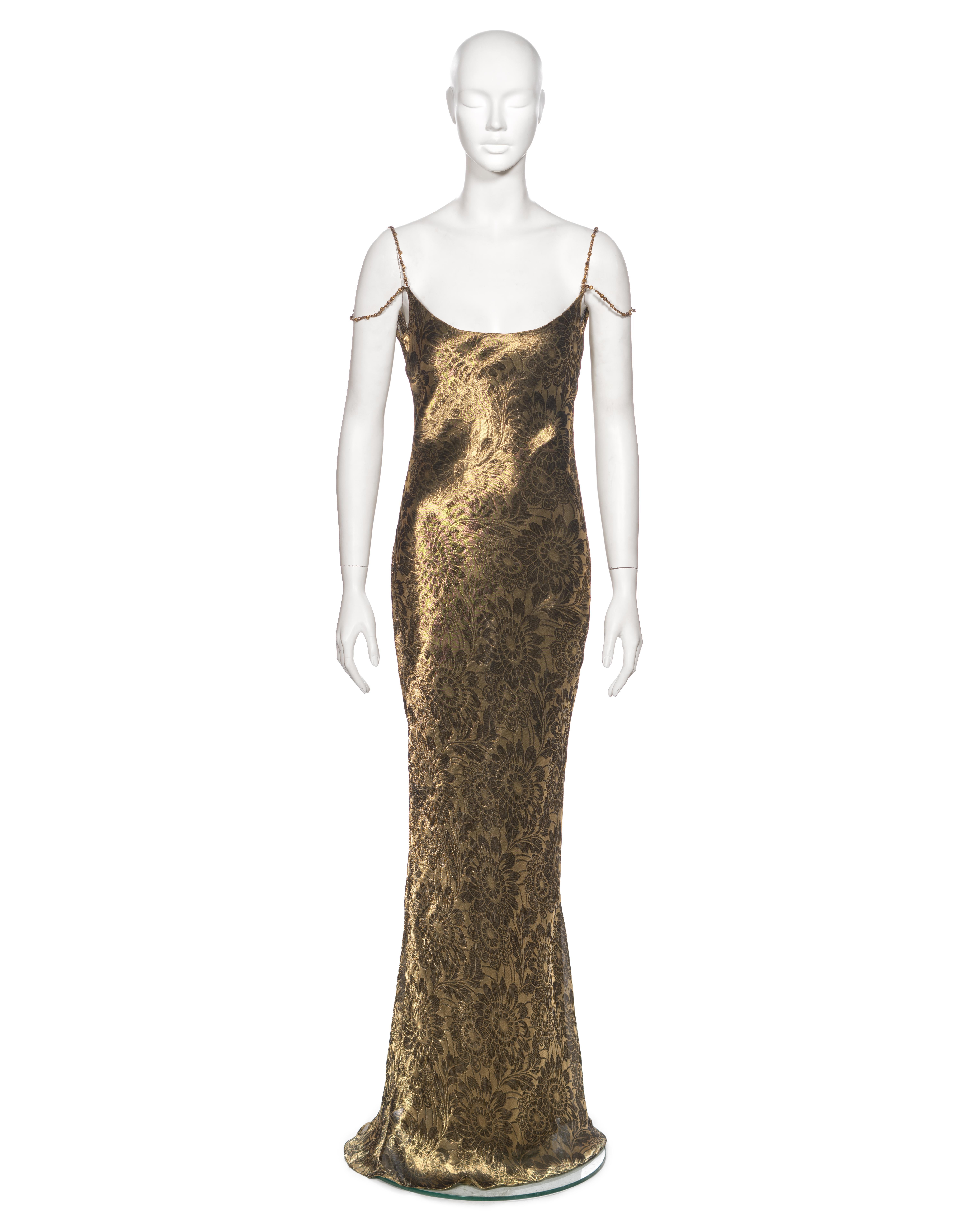 ▪ Archival Christian Dior Runway Evening Dress
▪ Creative Director: John Galliano
▪ Fall-Winter 1998
▪ Museum Grade 
▪ Crafted from a metallic antique gold tone bias-cut lurex silk damask, featuring an exquisite woven floral motif
▪ Adorned with