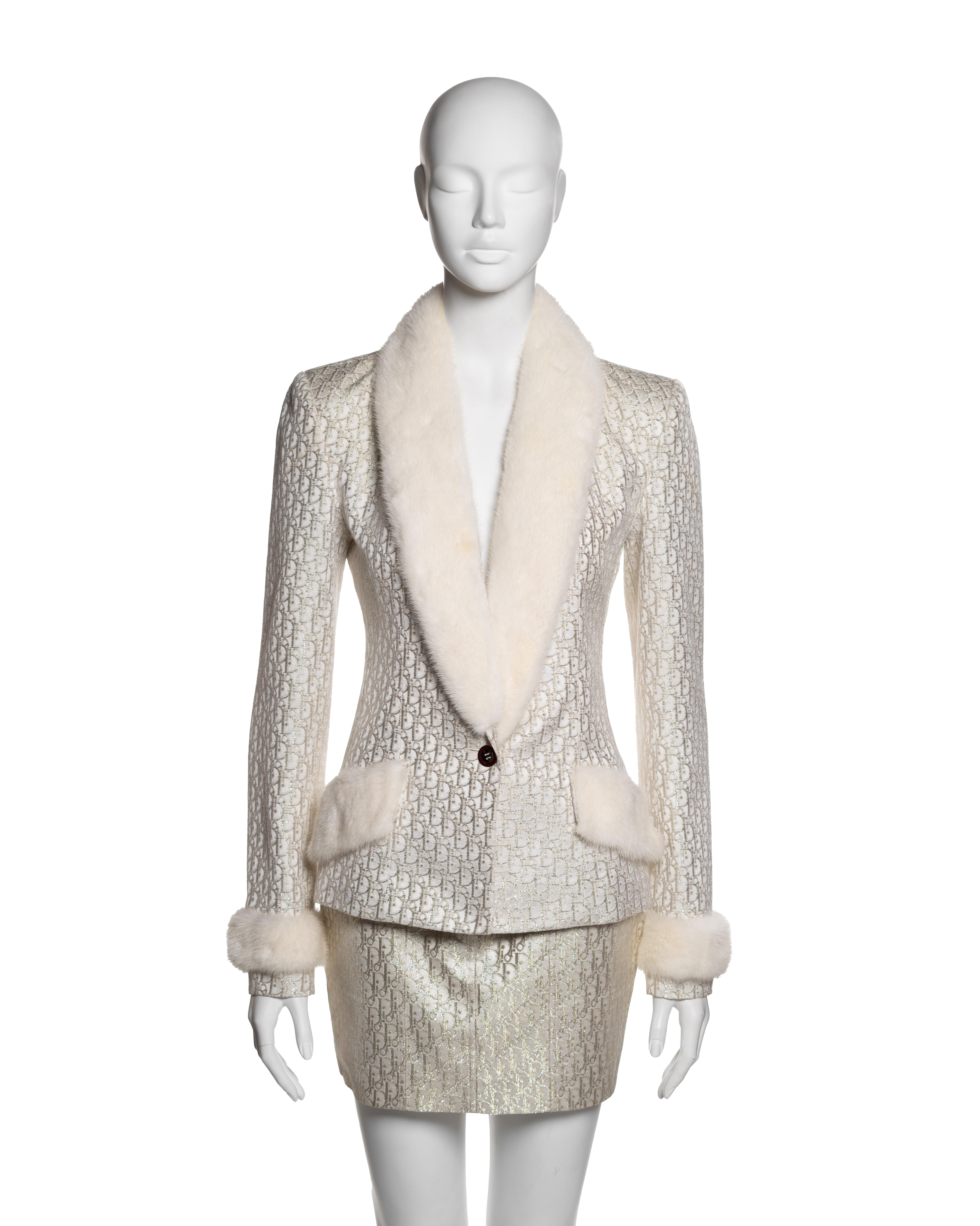 This Christian Dior ensemble, designed by John Galliano for the Fall-Winter 2004 collection, features a structured jacket and matching mini skirt, both crafted from jacquard woven with the house’s monogram motif—silver metallic for the jacket and