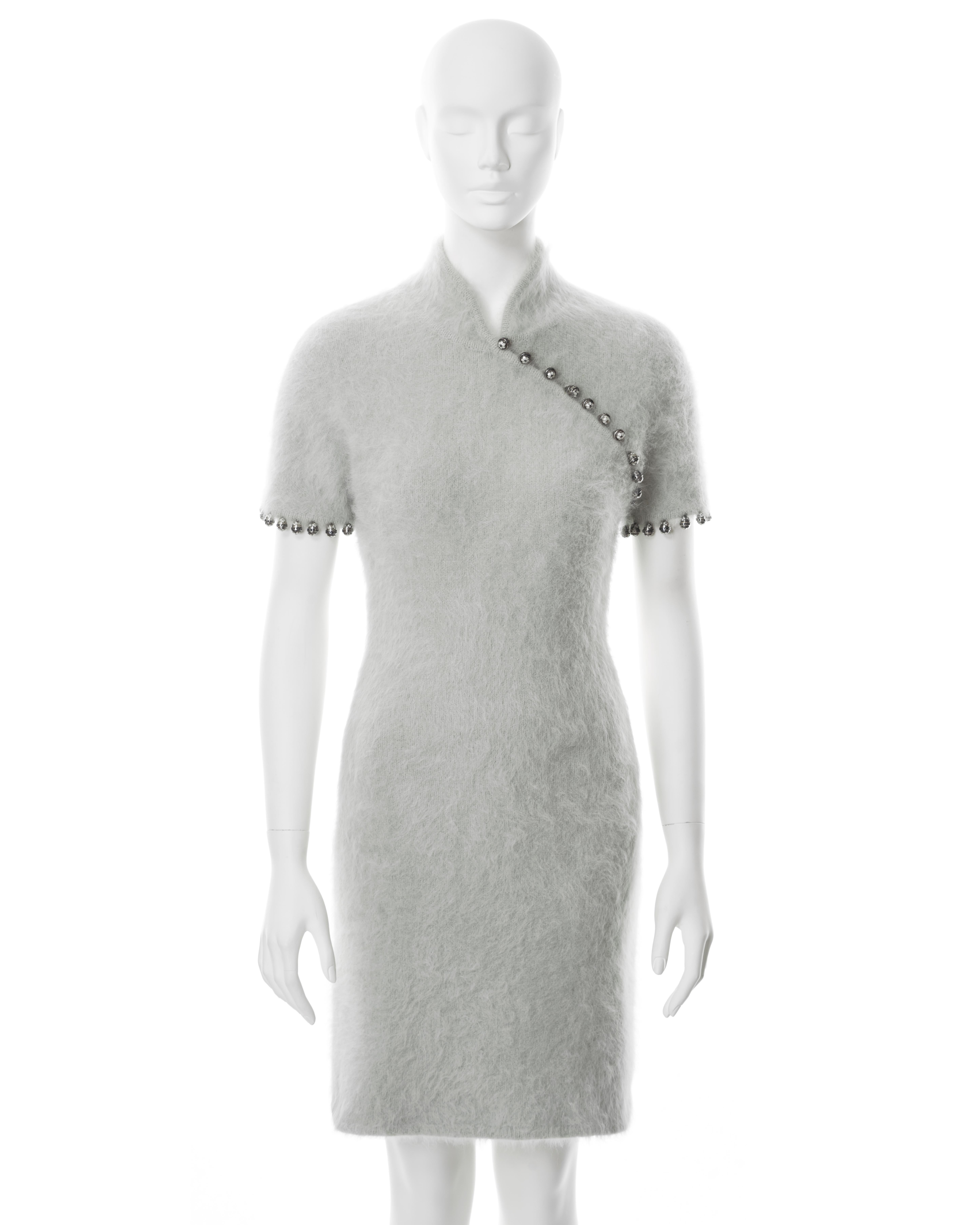 ▪ Christian Dior mint cheongsam-style dress
▪ Designed by John Galliano
▪ Sold by One of a Kind Archive
▪ Fall-Winter 1997
▪ Constructed from a fuzzy Angora and Wool knit fabric
▪ Asymmetric button-up neckline
▪ Standing collar 
▪ Figure-hugging fit