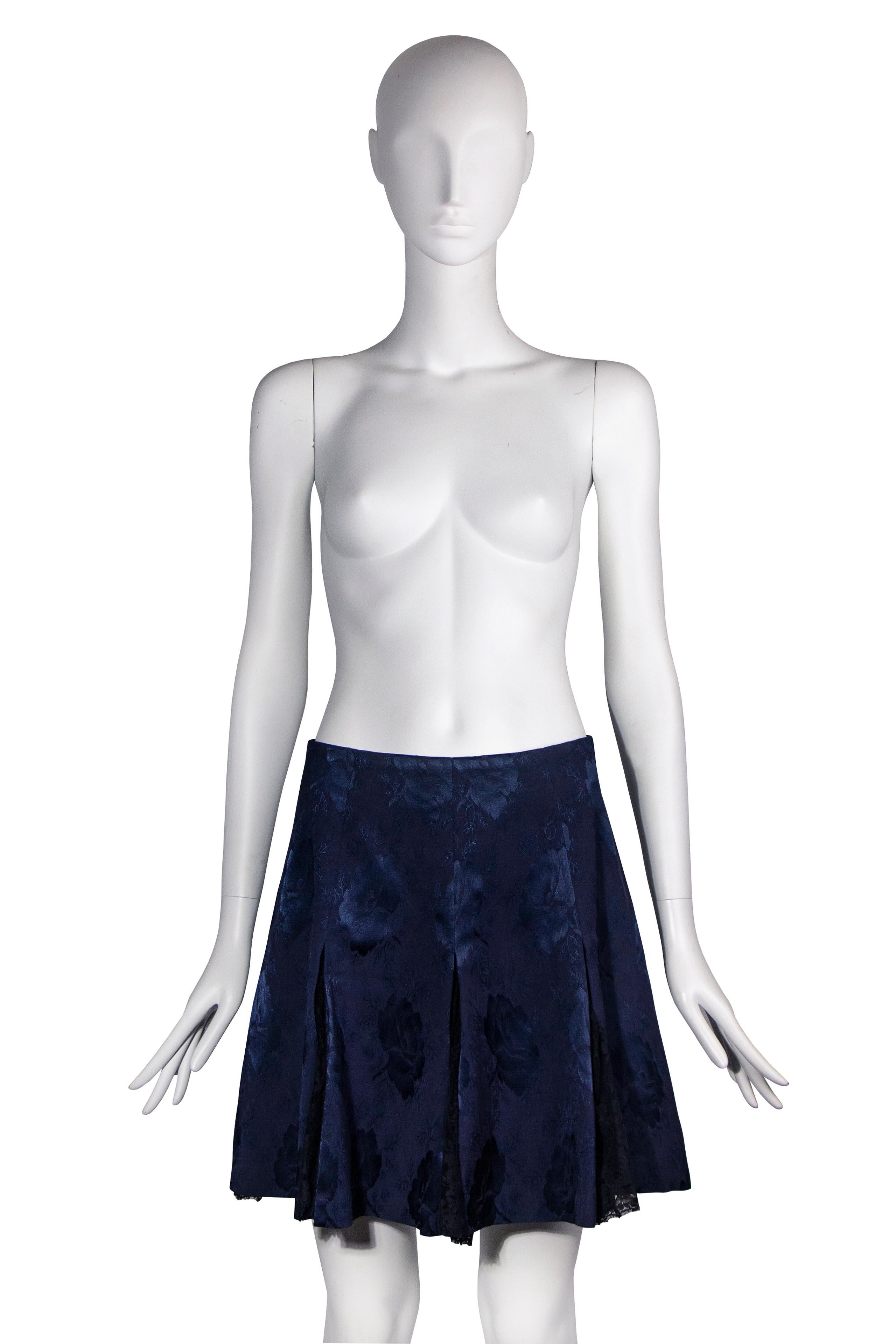 A Christian Dior by John Galliano ‘’Dior’s Little Sweetheart Pin-Ups” navy skirt, fall-winter 1997. Crafted from a luxurious silk brocade, this skirt is a testament to the exquisite craftsmanship of the Christian Dior atelier.  Black floral lace