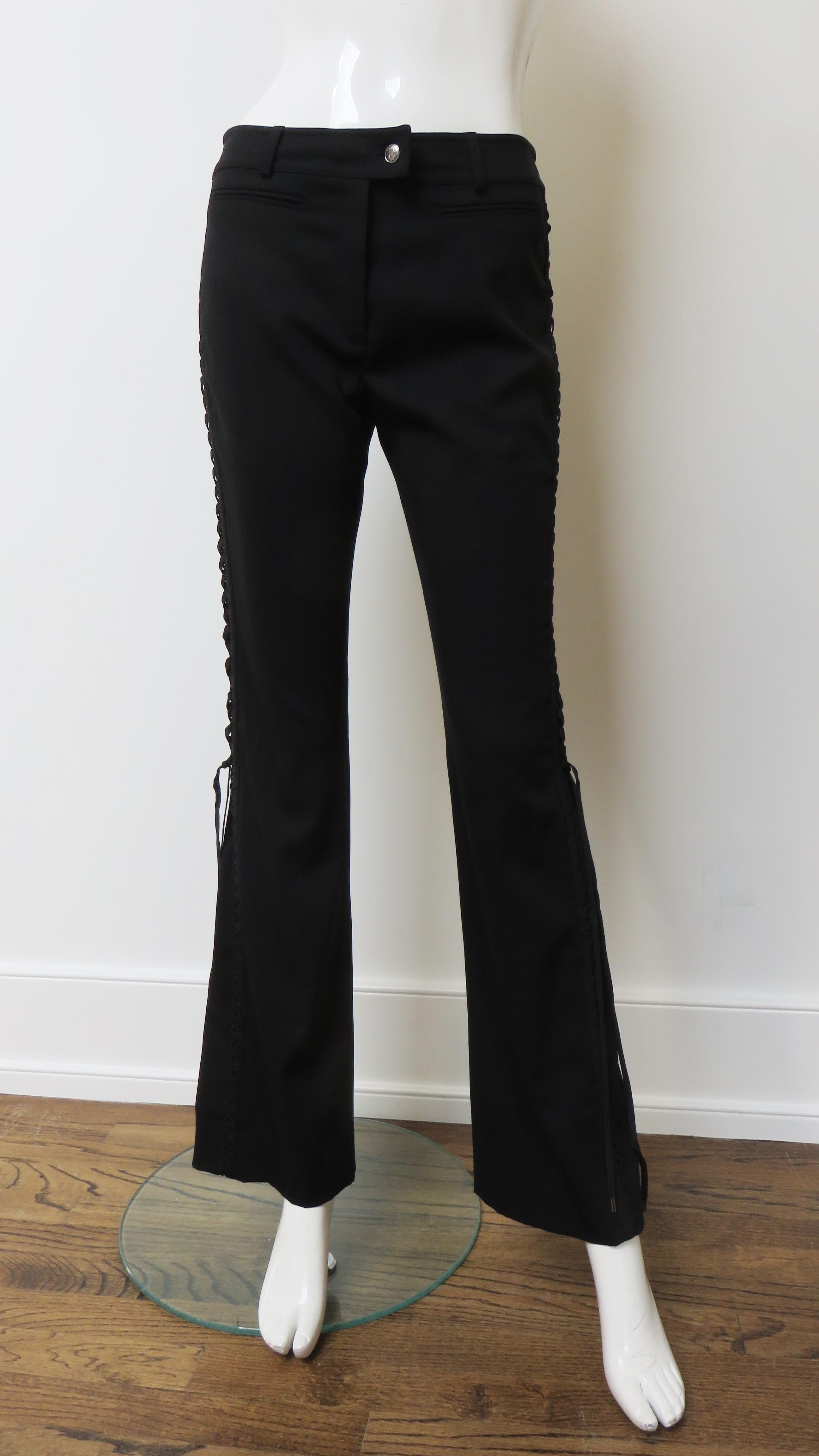 Fabulous black light weight wool pants with a bit of stretch from John Galliano for Christian Dior.  They are mid rise with front welt pockets and a silver metal Christian Dior inscribed front button on the waistband above a zipper closing.  The