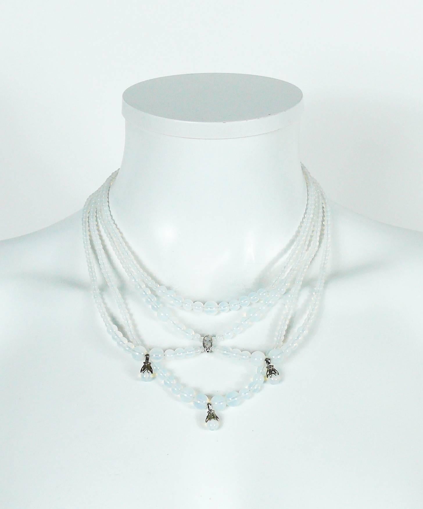 CHRISTIAN DIOR multi strand drapery necklace featuring opalescent glass beads simulating moon stones in a silver tone setting.

Created in the ateliers of french parurier ROBERT GOOSSENS.

Marked CHRISTIAN DIOR Boutique.

Indicative measurements :