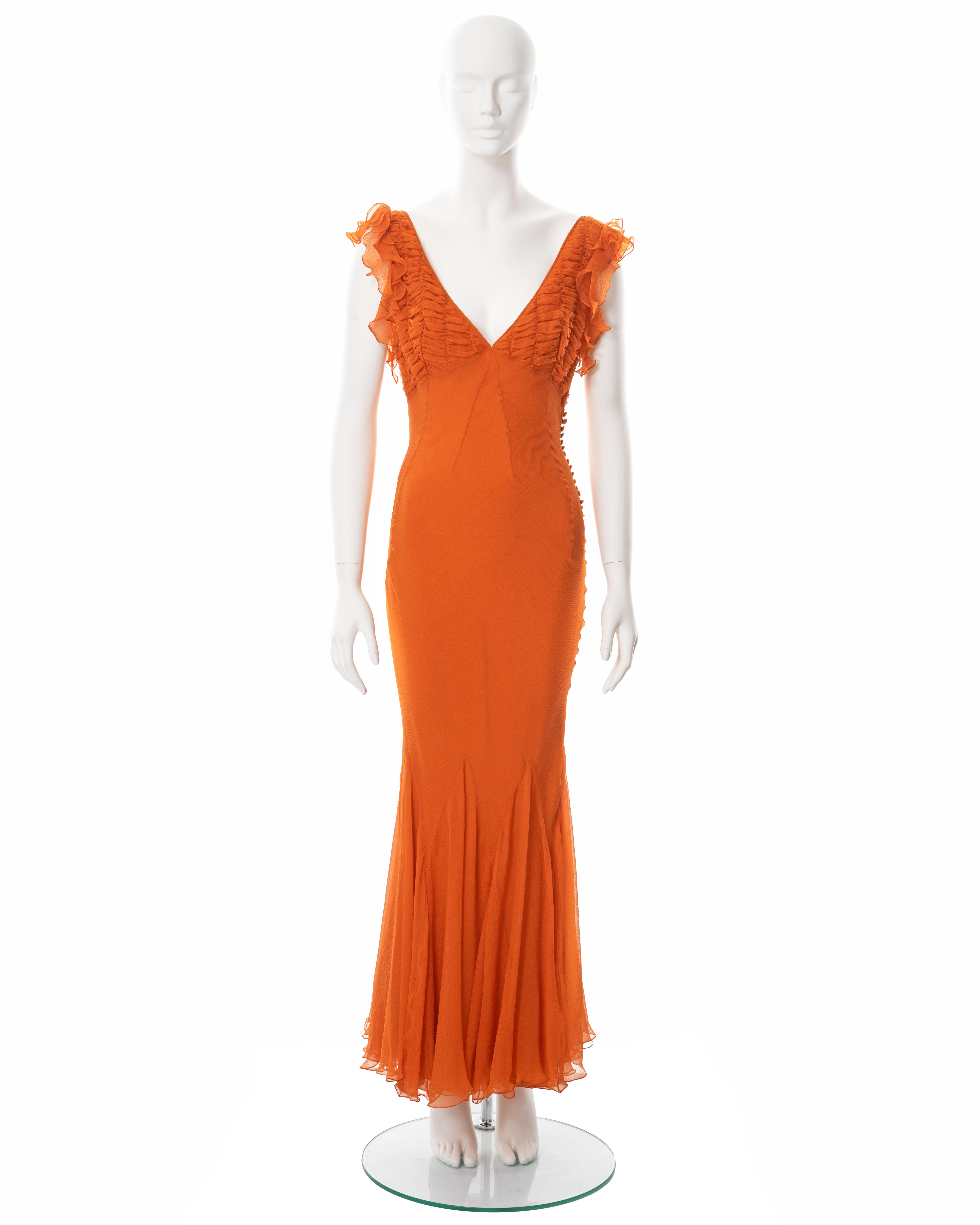 ▪ Christian Dior orange silk evening dress
▪ Designed by John Galliano
▪ Sold by One of a Kind Archive
▪ Constructed from orange bias-cut crinkled silk chiffon 
▪ Smocked chiffon on the bust with ruffled frill trim 
▪ V-neck 
▪ Multiple fabric