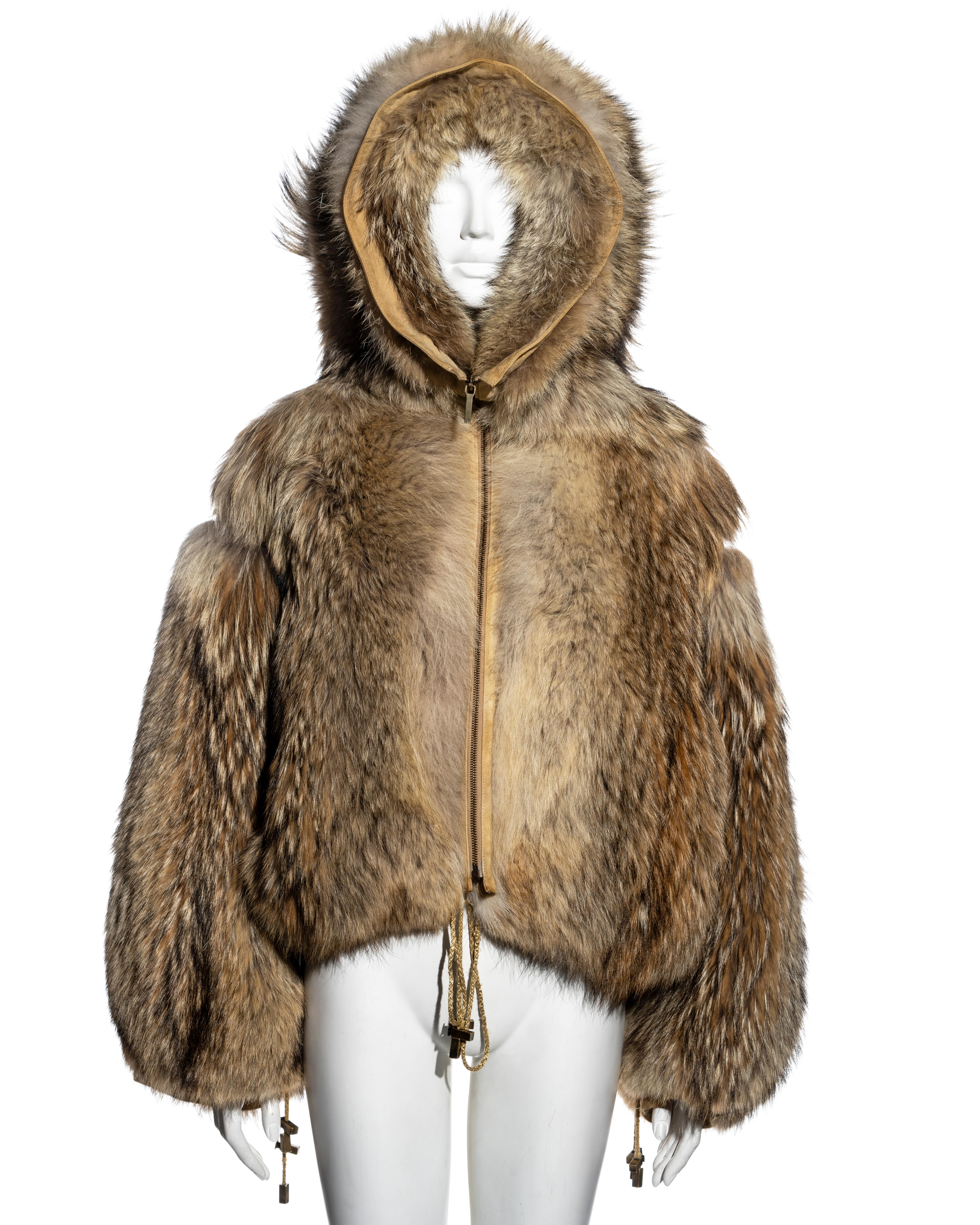 ▪ Christian Dior fur bomber jacket 
▪ Designed by John Galliano 
▪ Coyote fur
▪ Oversized fit
▪ Hood with fur lining 
▪ Drawstring ties at the waist and cuffs 
▪ Silk lining
▪ FR 38 - UK 10 - US 6
▪ 100% Coyote, 100% Silk
▪ Matching pants sold