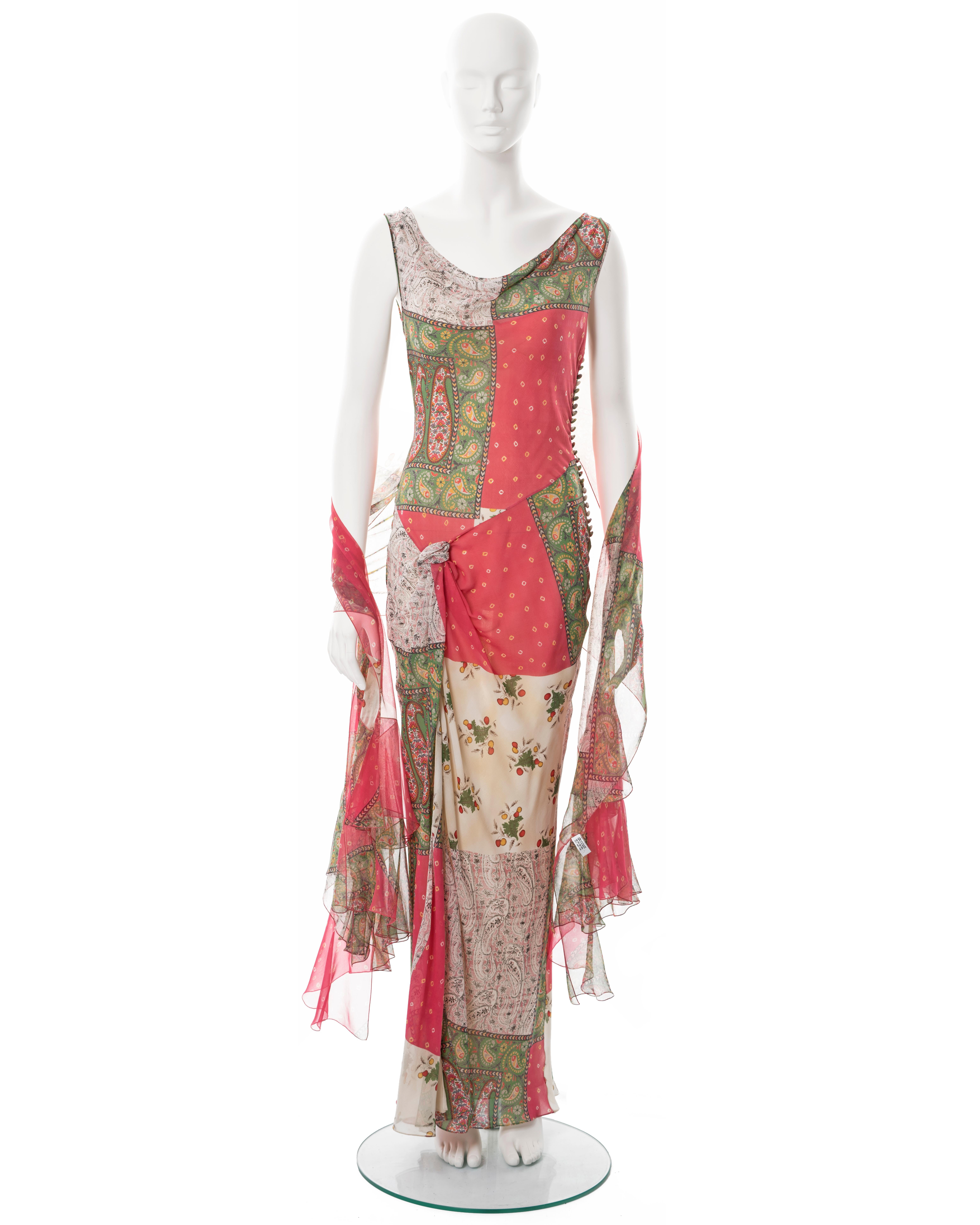 ▪ Christian Dior bias-cut silk dress and scarf 
▪ Designed by John Galliano
▪ Spring-Summer 2004
▪ Constructed from bias-cut paisley patchwork-print silk in pink, green and ivory 
▪ Cowl neck 
▪ Floor-length skirt with leg slit 
▪ Fabric button