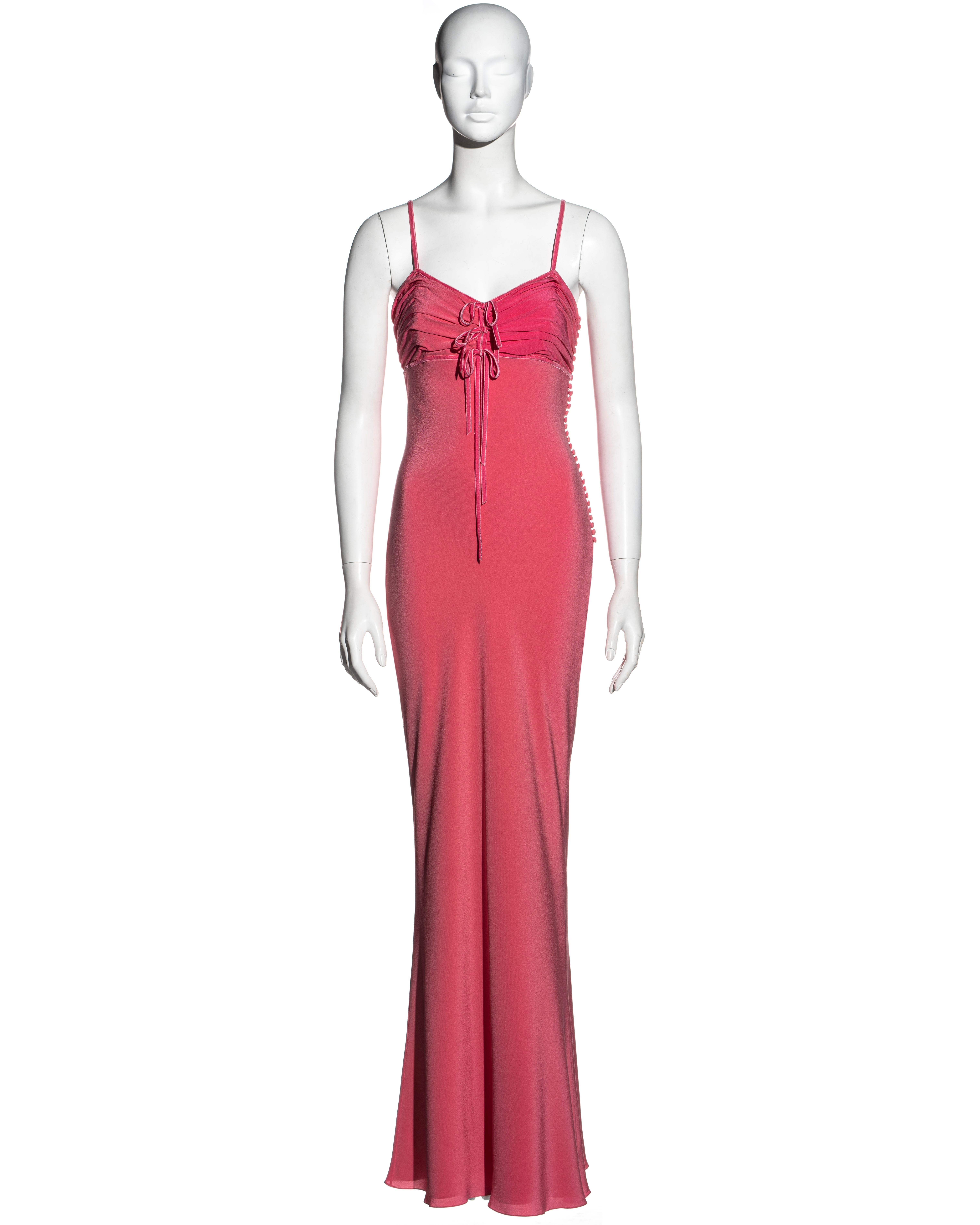▪ Christian Dior salmon pink silk maxi dress
▪ Designed by John Galliano 
▪ Pleated bust 
▪ Three velvet bow ties
▪ Velvet spaghetti straps 
▪ Fabric buttons at the side seam 
▪ FR 40 - UK 40 - US 8
▪ Spring-Summer 2006