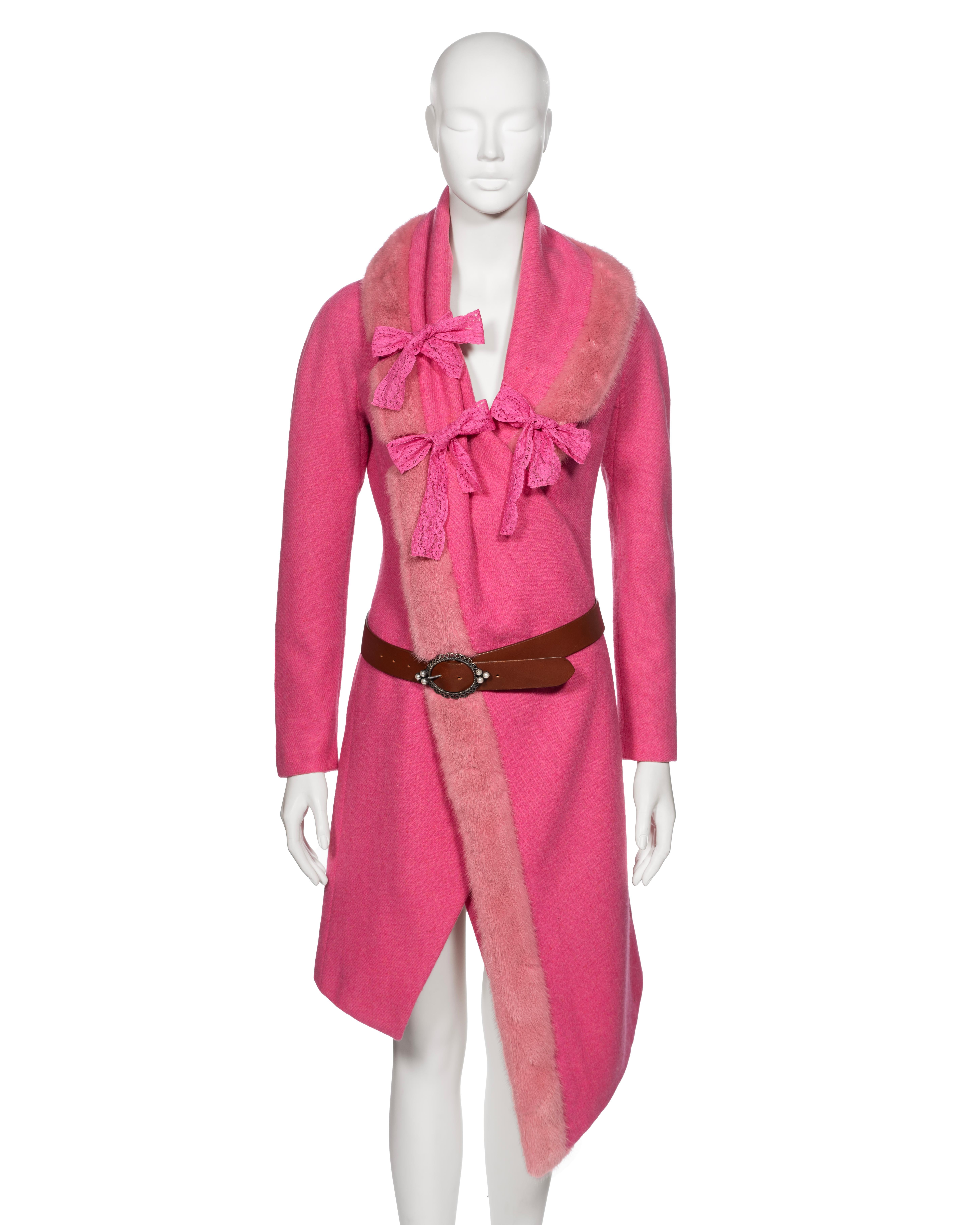 ▪ Archival Christian Dior Runway Coat
▪ Creative Director: John Galliano
▪ Fall-Winter 1998
▪ Sold by One of a Kind Archive
▪ Crafted from exquisite pink wool tweed
▪ Boasts an asymmetric large shawl lapel cascading to the hemline, trimmed with