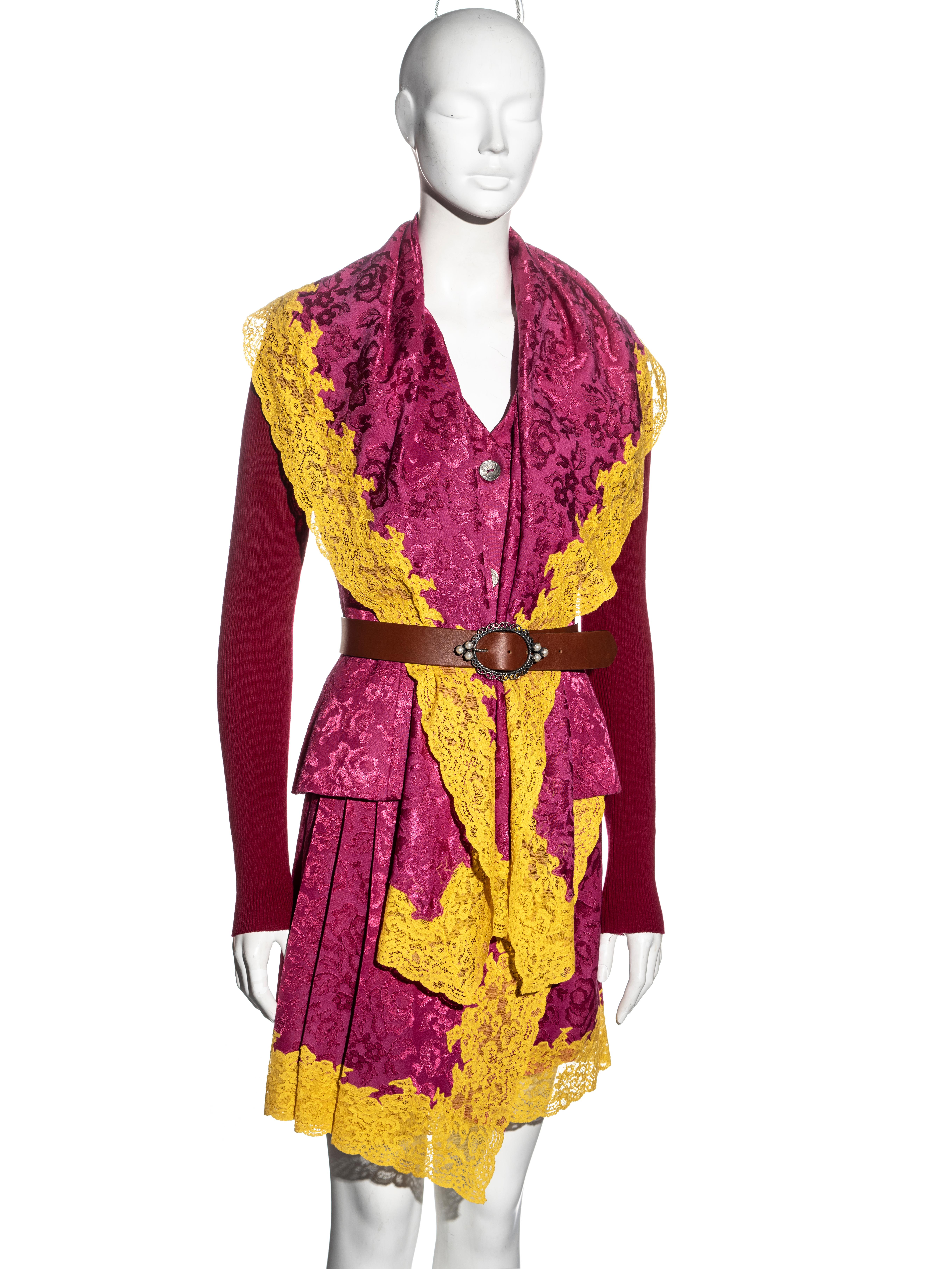 ▪ Christian Dior skirt suit
▪ Designed by John Galliano
▪ Pink jacquard wool 
▪ Yellow Calais lace trim 
▪ Single-breasted jacket with scarf collar
▪ Ribbed-knit sleeves
▪ Pleated wrap skirt 
▪ Brown leather belt 
▪ Jacquard silk lining 
▪ FR 38 -