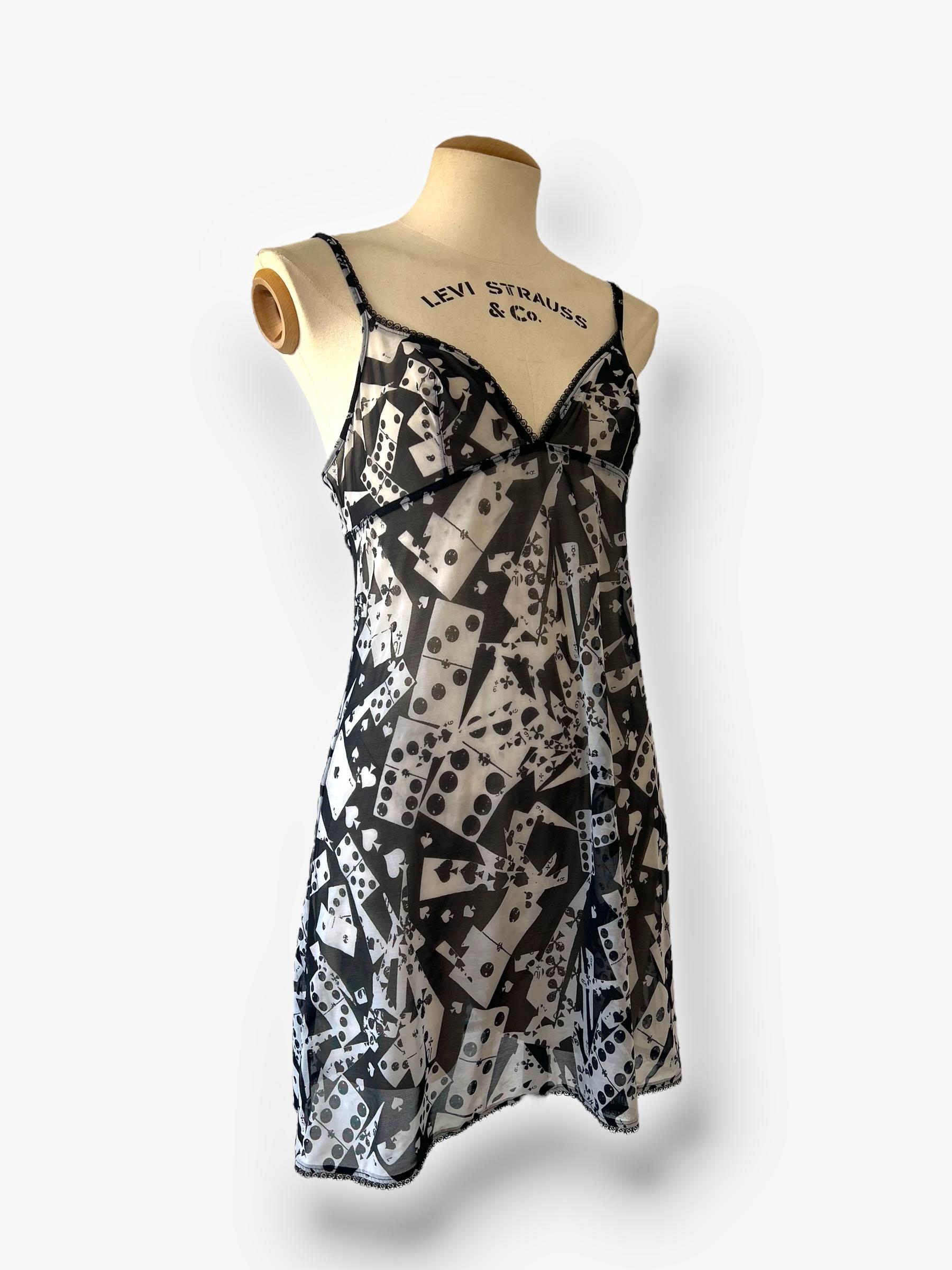 

Embrace John Galliano’s whimsical design aesthetic with this captivating slip dress, featuring an all-over playing card and domino print. The fluid silhouette, delicate spaghetti straps, and subtly flared hem exude effortless femininity. Crafted