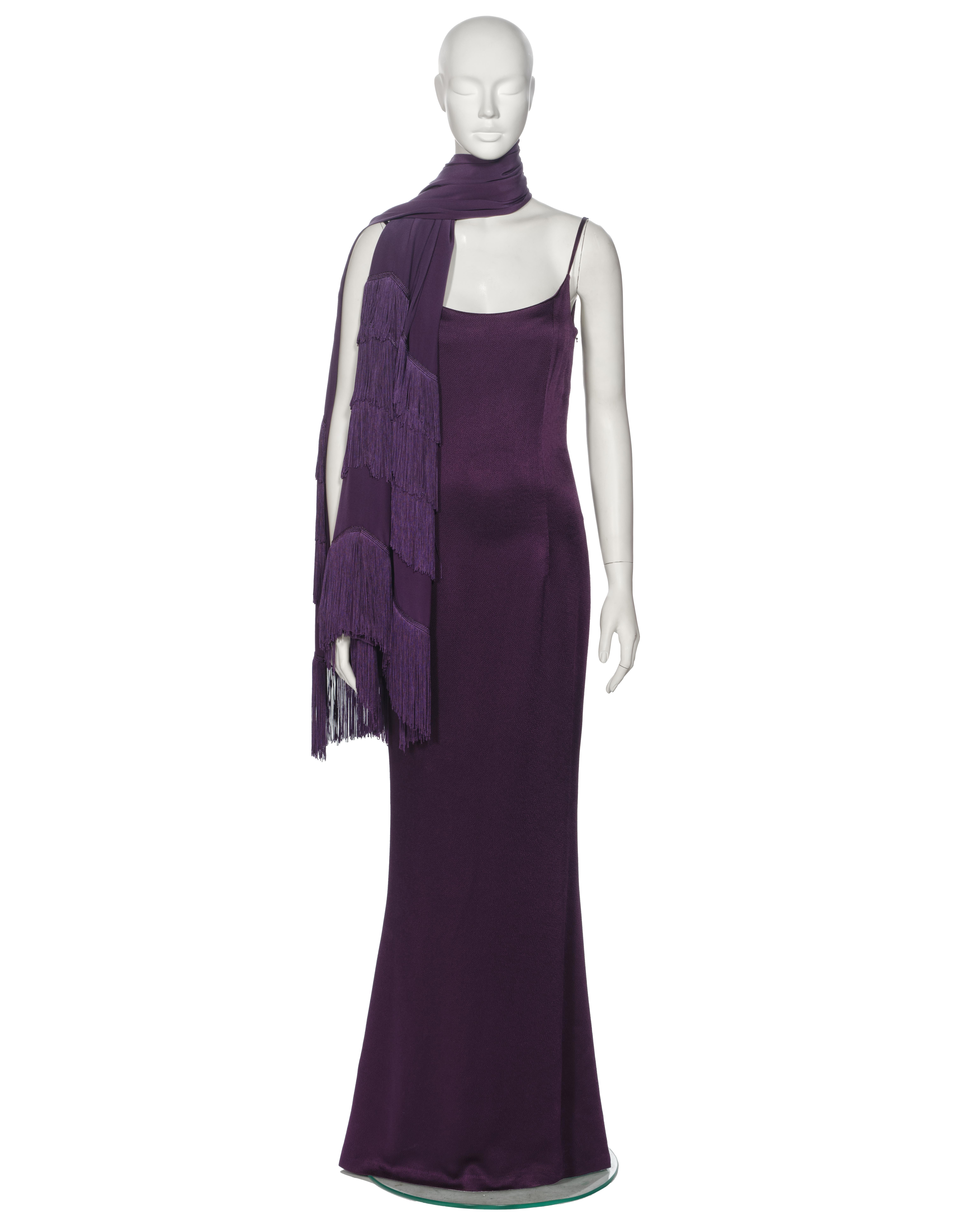 ▪ Christian Dior Evening Dress and Shawl Ensemble 
▪ Creative Director: John Galliano
▪ Spring-Summer 1998
▪ Sold by One of a Kind Archive
▪ Constructed from a deep purple hammered satin 
▪ Scoop neckline design 
▪ Spaghetti straps 
▪ Flared skirt