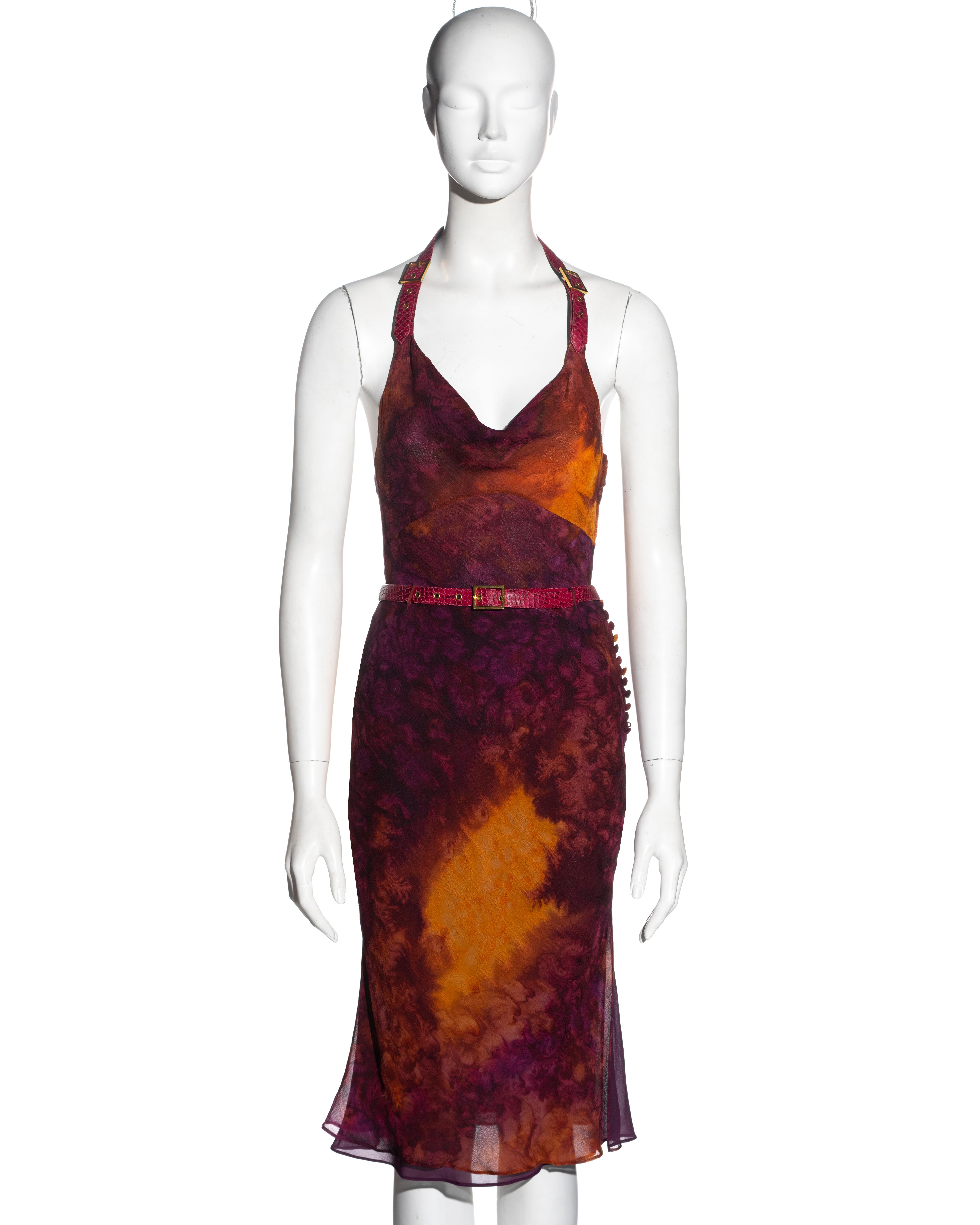 ▪ Christian Dior silk top and skirt set
▪ Designed by John Galliano
▪ Purple and orange tie-dyed silk chiffon 
▪ Snakeskin print calfskin leather halter-neck and belt
▪ Gold-tone metal buckles
▪ Cowl neck
▪ Mid-length skirt with side slit
▪ Can be