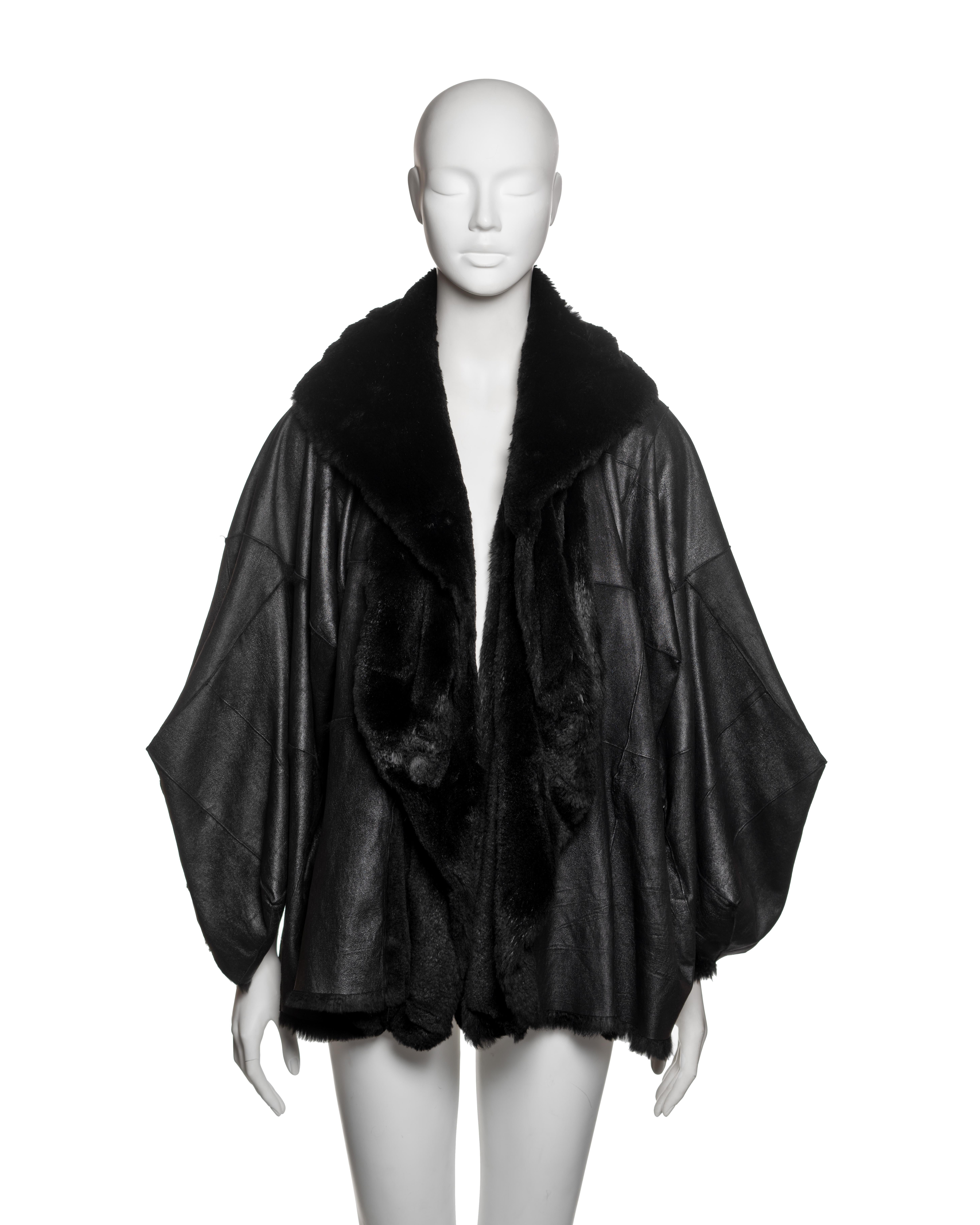 Reversible batwing-sleeved coat by John Galliano for Christian Dior, Fall-Winter 2003, constructed in black sheared rabbit fur with a leather finish on one side and high-lustre pile on the reverse. The voluminous silhouette is shaped through complex