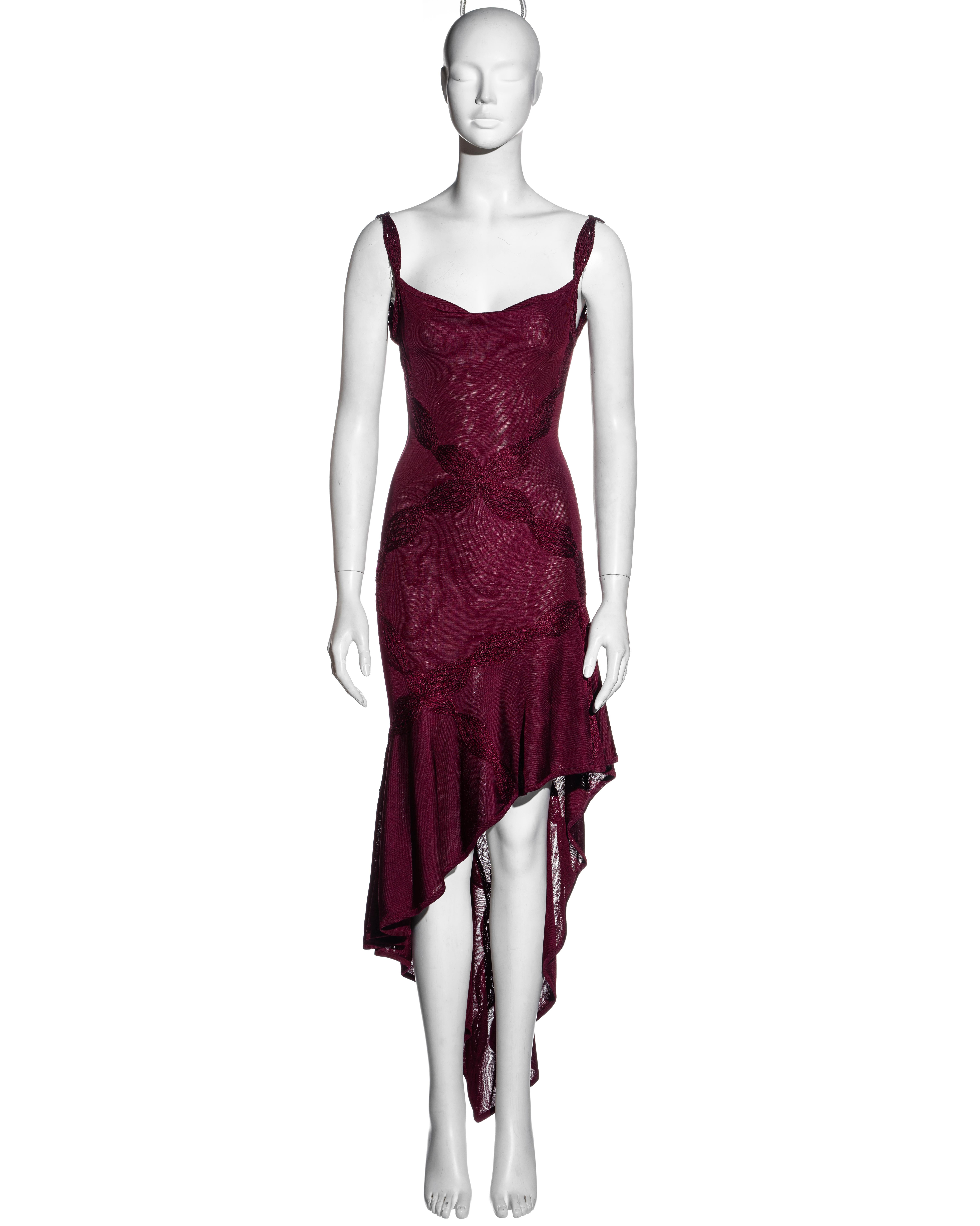 ▪ Christian Dior ruby red rayon knit dress 
▪ Designed by John Galliano 
▪ Cowl neckline  
▪ Bias-cut 
▪ Asymmetric hemline  
▪ Large braided thread appliques  
▪ Low back  
▪ FR 36 - UK 8 - US 4 
▪ Spring-Summer 2001 
▪ 100% Viscose / Rayon 
▪ Made