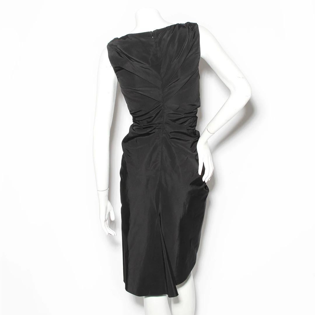 Christian Dior by John Galliano Dress
Made in Italy 
Black 
Sleeveless
V-neckline 
Ruched detailing down front of dress
Fitted sheath style dress
Invisible zipper down back of dress with hook and eye closure at top
51% Cotton, 49% Silk fabric