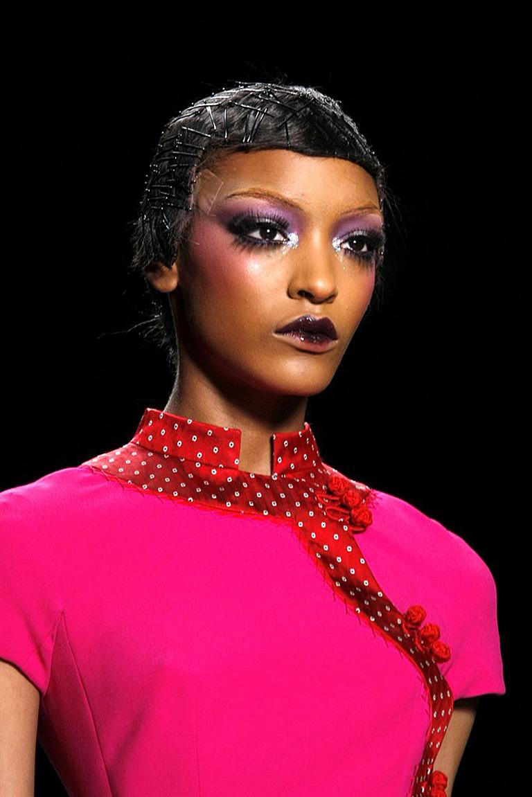 The Fall 2009 Dior Runway Collection by John Galliano was created lightly based on the orientalism of Paul Poiret and a century past Parisian Couture fashion.   

Fashioned in  raspberry and red silk and wool dress designed with an Asian influence