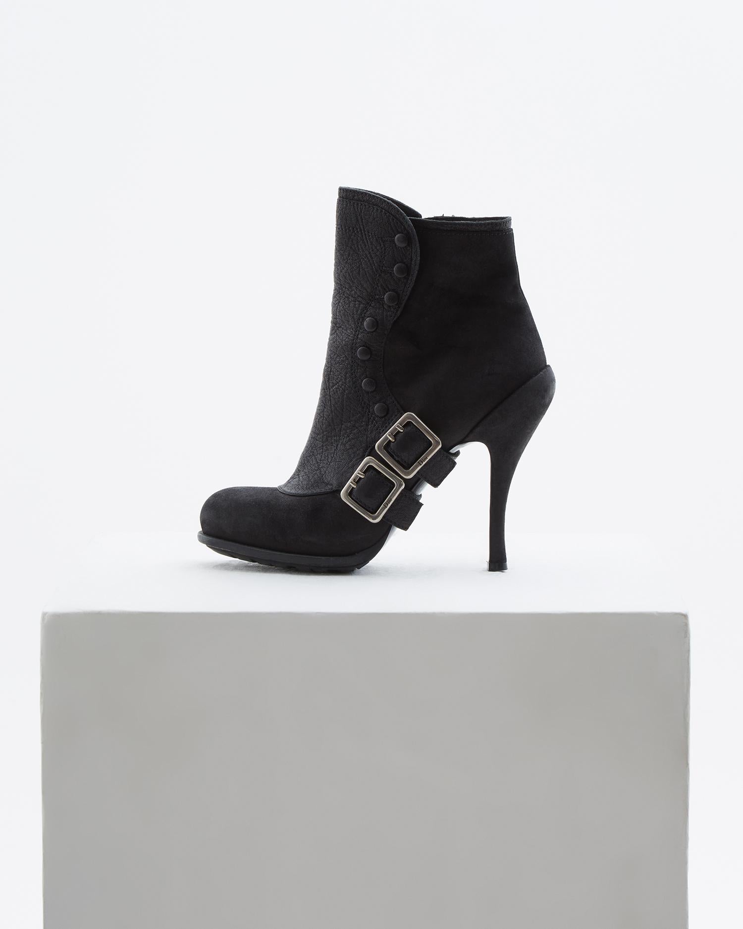 - Designed by John Galliano 
- Sold by Skof.Archive
- Black leather ankle boots accented by weathered silver metal 