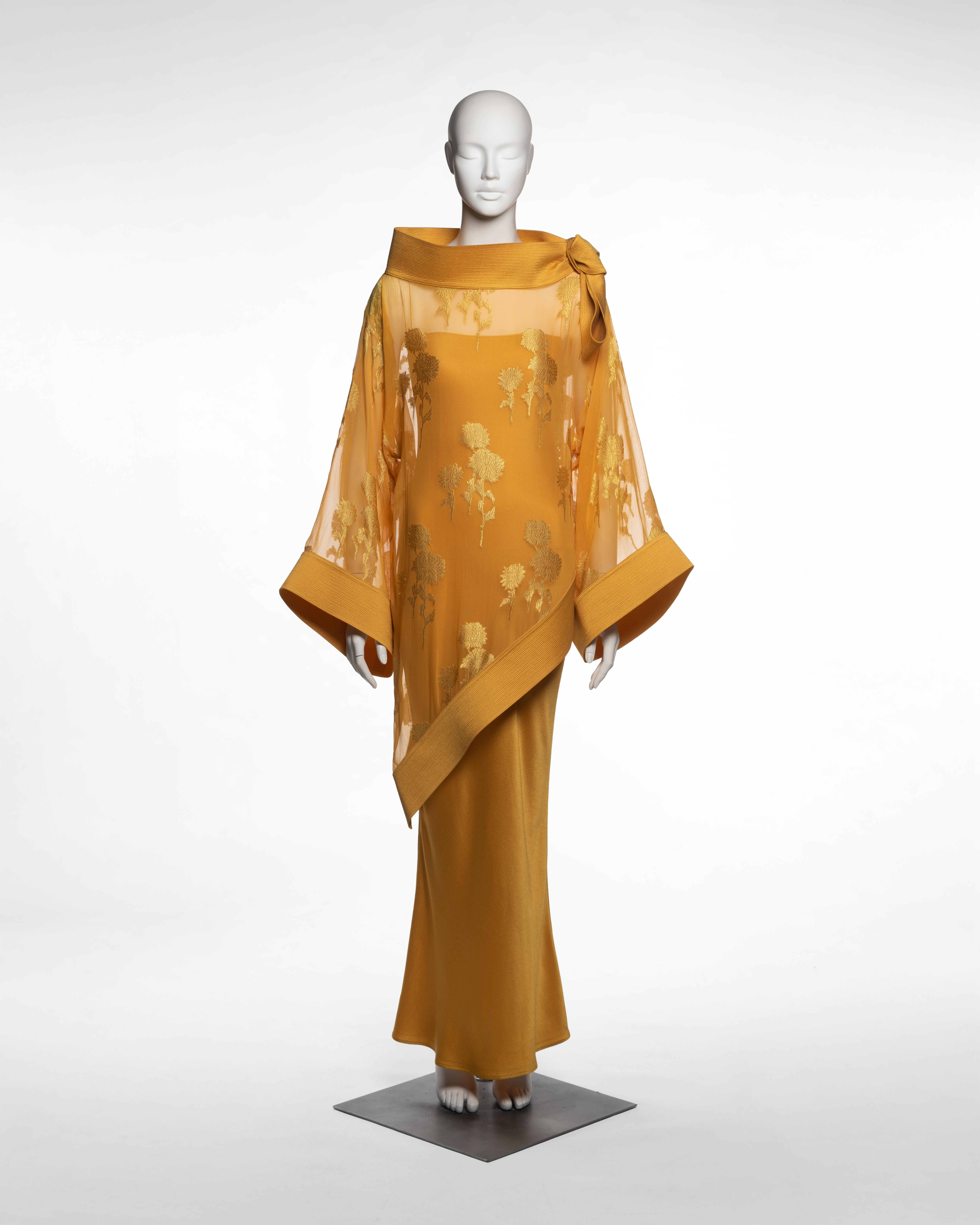 Runway ensemble by John Galliano for Christian Dior, Fall-Winter 1999. The look comprises a bias-cut floor-length slip dress in hammered silk satin with narrow spaghetti straps, layered beneath a sheer tunic woven from saffron silk organza. The