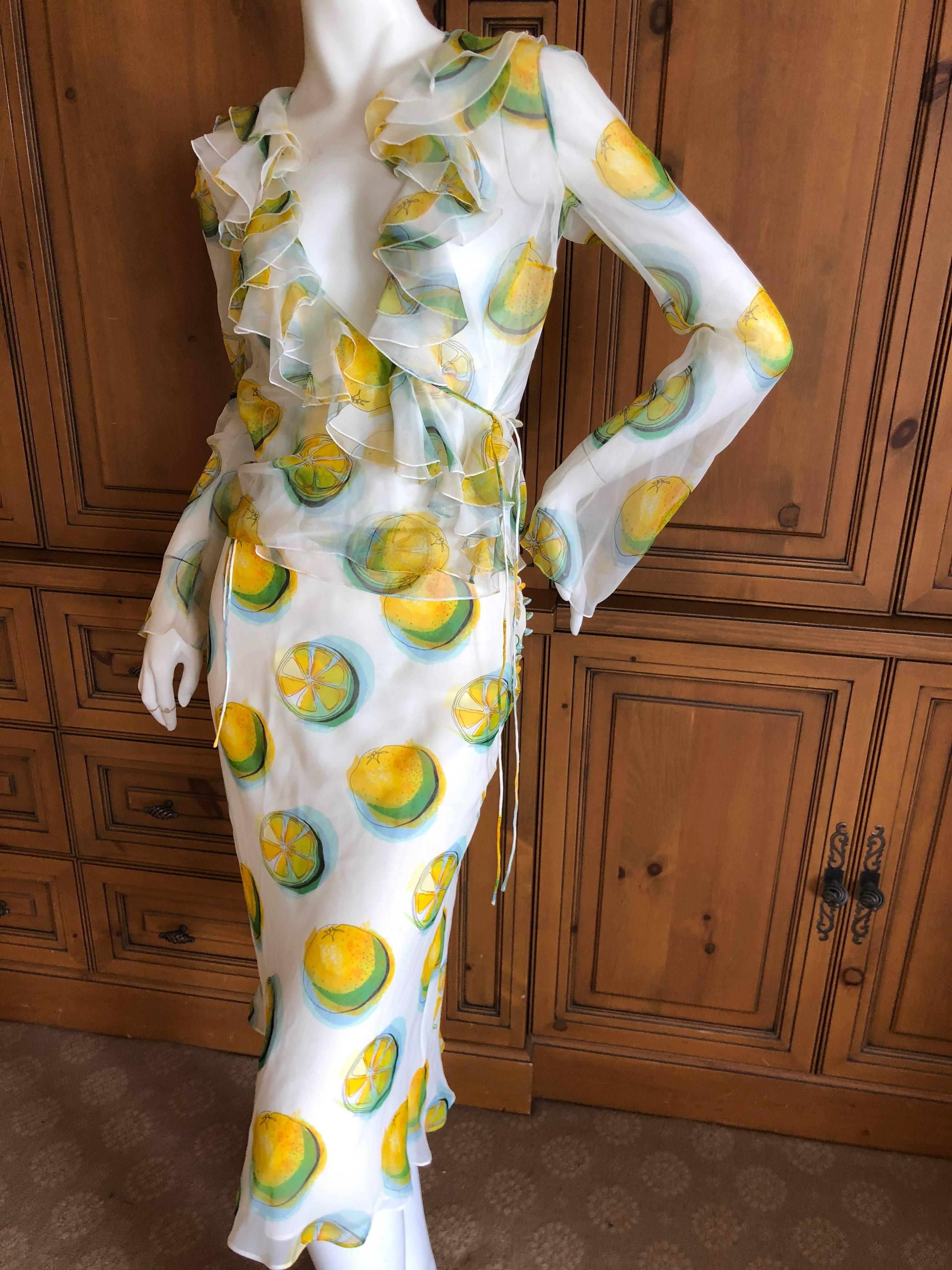 Christian Dior by John Galliano Silk Two Piece Ruffled Dress with delightful lemon print.
Featuring a sheer wrap style ruffled top and a lined pencil skirt with silk covered buttons down the side.

Size 36, top size 38 skirt
 
Bust 36