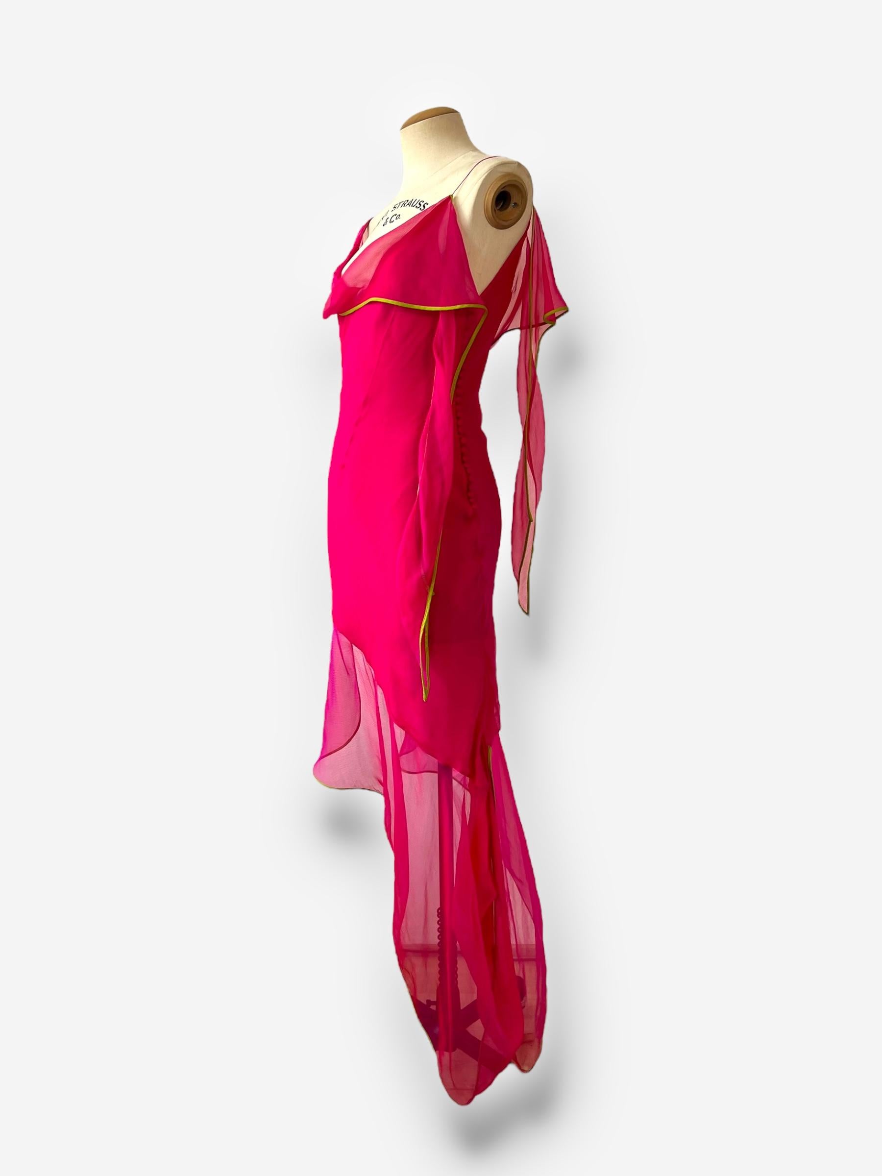

This exquisite silk dress from Dior’s 2005 collection showcases John Galliano’s signature flair for drama and romanticism. The asymmetric bias-cut silhouette drapes beautifully on the body, enhanced by delicate button closures that add a refined