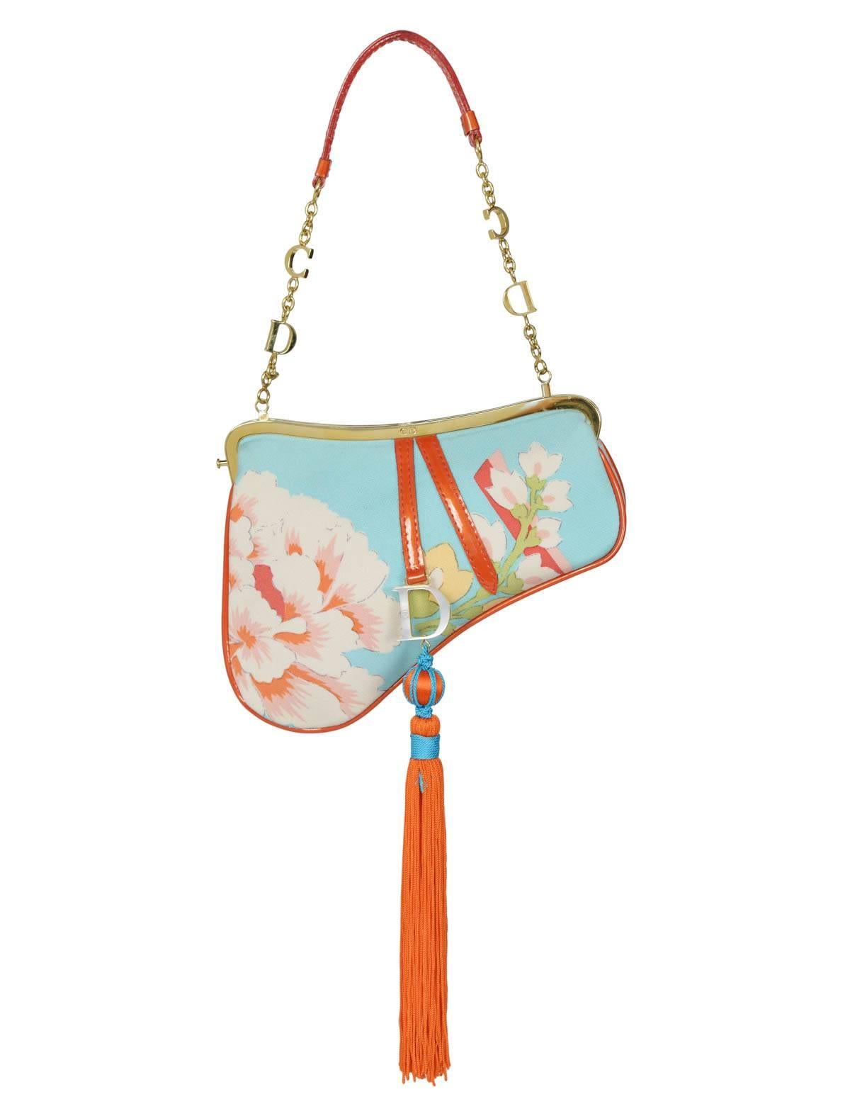 Christian Dior by John Galliano silk floral mini saddle evening bag with large red orange tassel, CD gold hardware and red trim. Dior print on backside. Collection AW 2003. 

