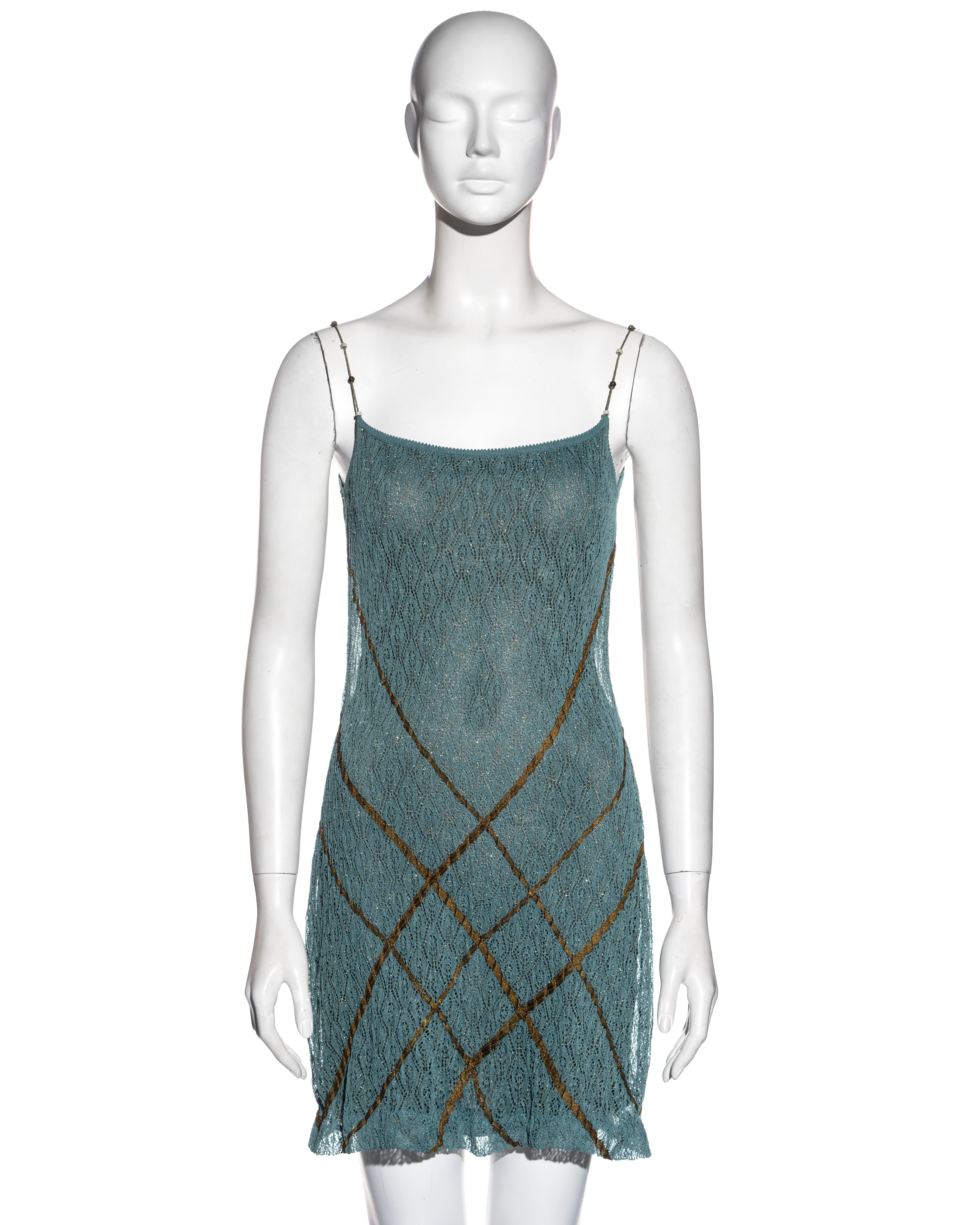▪ Christian Dior teal slip dress
▪ Designed by John Galliano 
▪ Double-layered
▪ Fine knitted lace 
▪ Antique gold lamé ribbon criss-cross appliqués 
▪ Gold lurex underdress 
▪ Two-tone string cord shoulder straps with antique beads 
▪ Size Medium