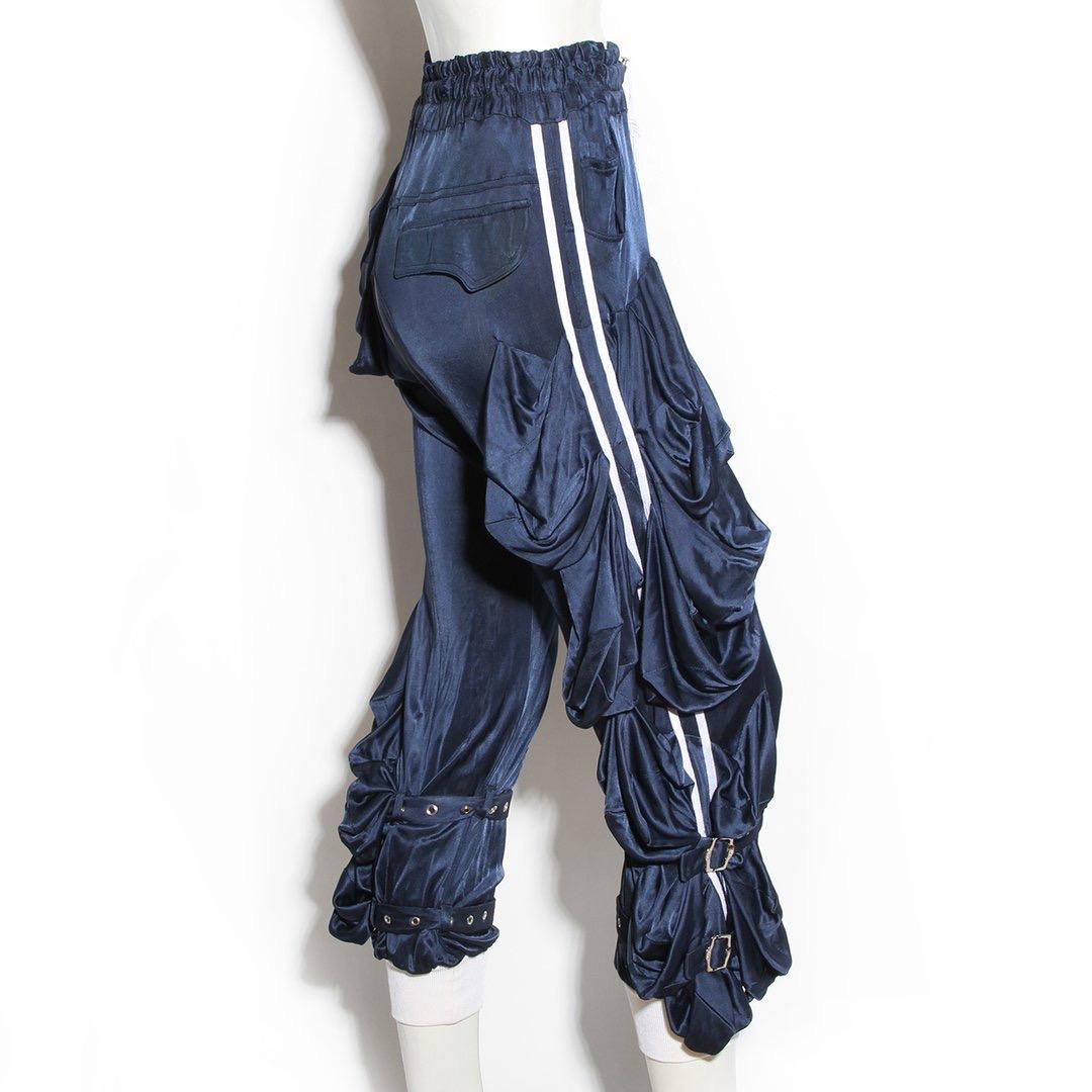 Track pants by John Galliano for Christian Dior
Spring 2004 Ready-to-Wear
Navy silk blend 
Elastic waist with adjustable elastic drawstring 
Dual side pockets 
White stripe detail down side of pant legs 
Draping on right thigh and both pant legs 