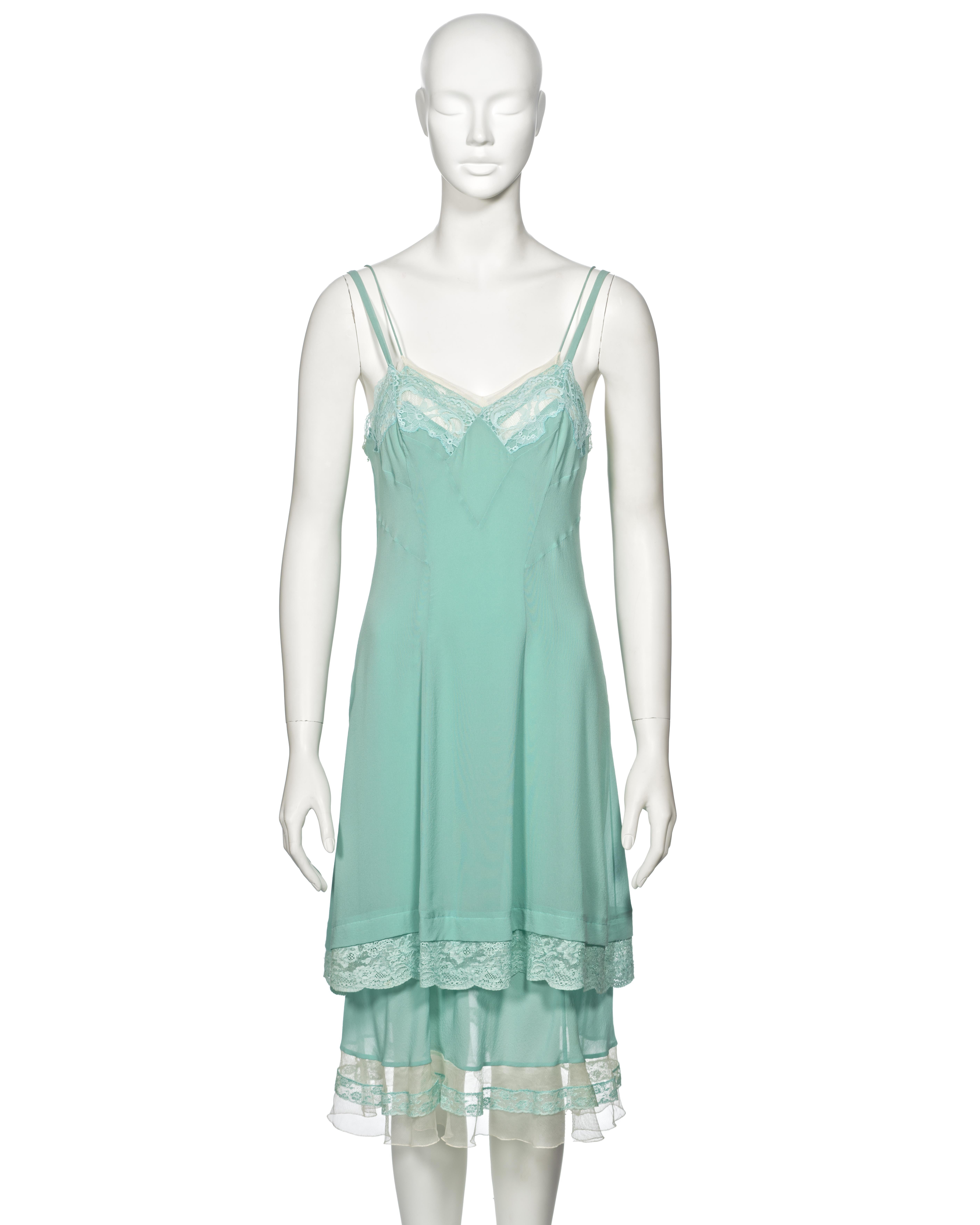 ▪ Archival Christian Dior Double Layered Slip Dress
▪ Creative Director: John Galliano
▪ Spring-Summer 2005
▪ Sold by One of a Kind Archive
▪ Constructed from two attached slip dresses 
▪ Turquoise silk 
▪ Ivory lace inserts and trimmings 
▪ Size: