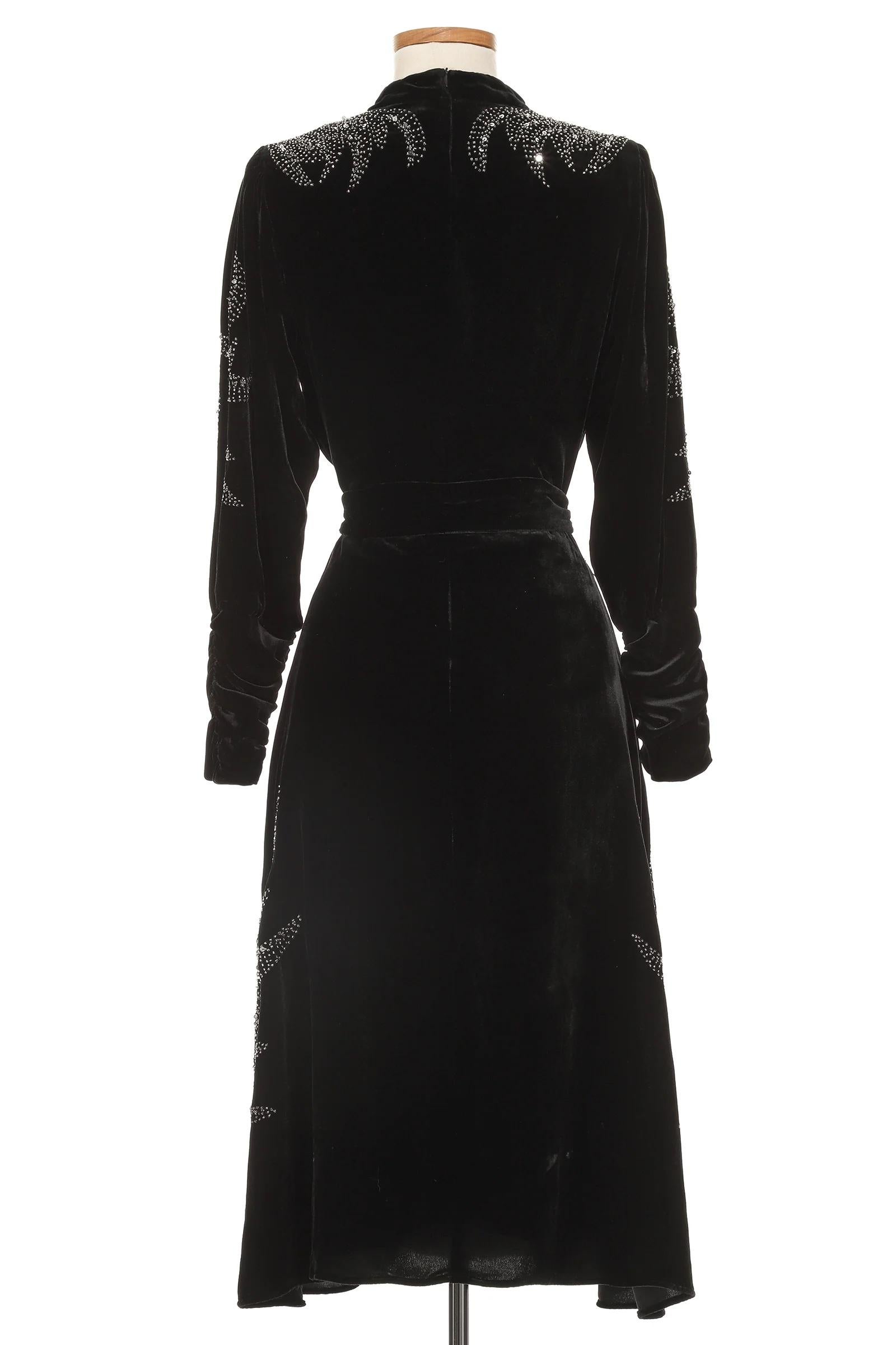 VINTAGE GRACE NY

This stunning Christian Dior by John Galliano velvet dress epitomizes old-world glamour with a modern edge. Crafted from sumptuous black velvet, the dress features a high neckline and long sleeves, perfectly balanced by intricate