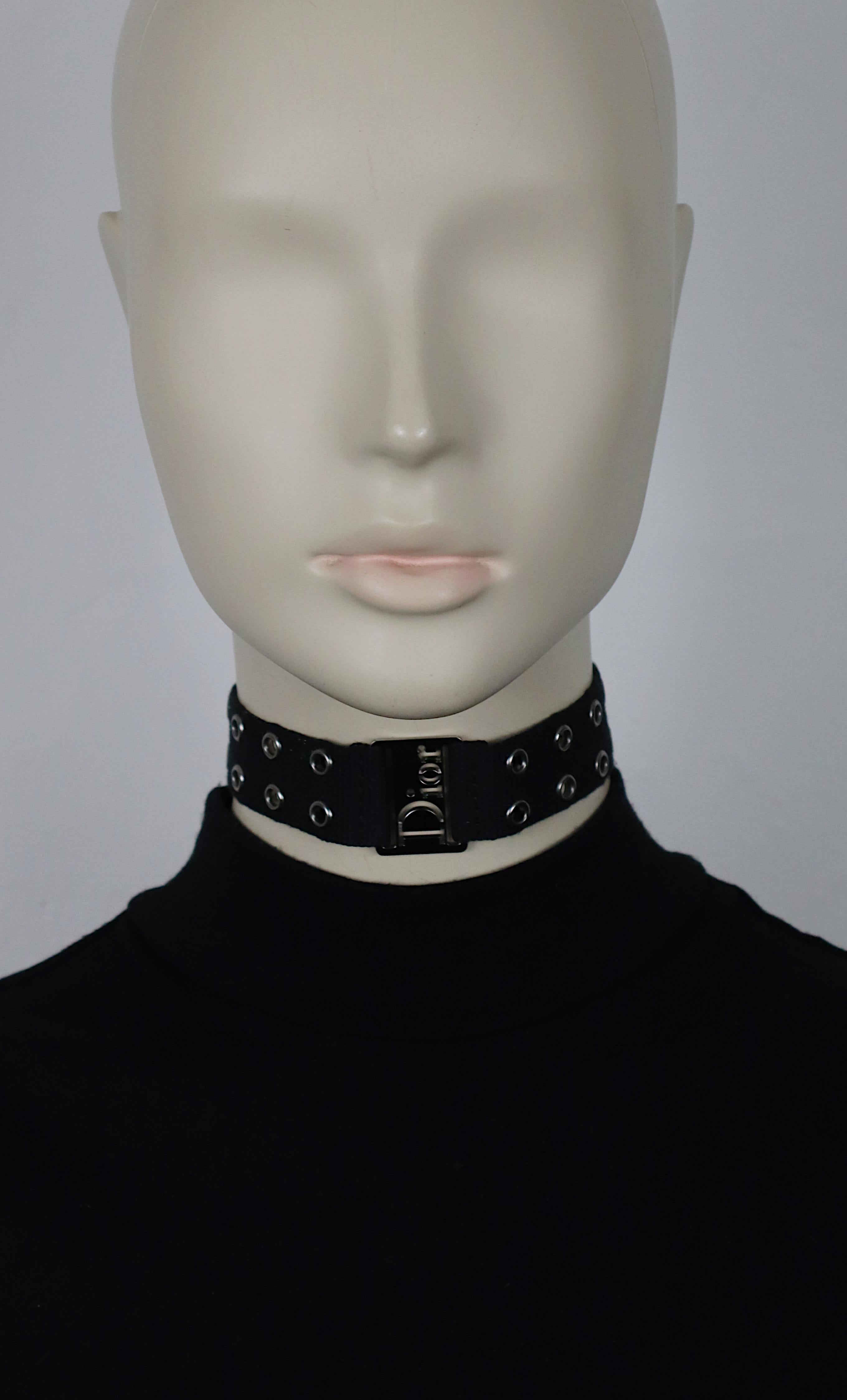 CHRISTIAN DIOR by JOHN GALLIANO vintage black nylon strap choker necklace embellished with silver tone eyelets, cut-out DIOR logo at the center, silver tone hardware.

Adjustable hook clasp closure.

Embossed DIOR and CD.

Indicative measurements :